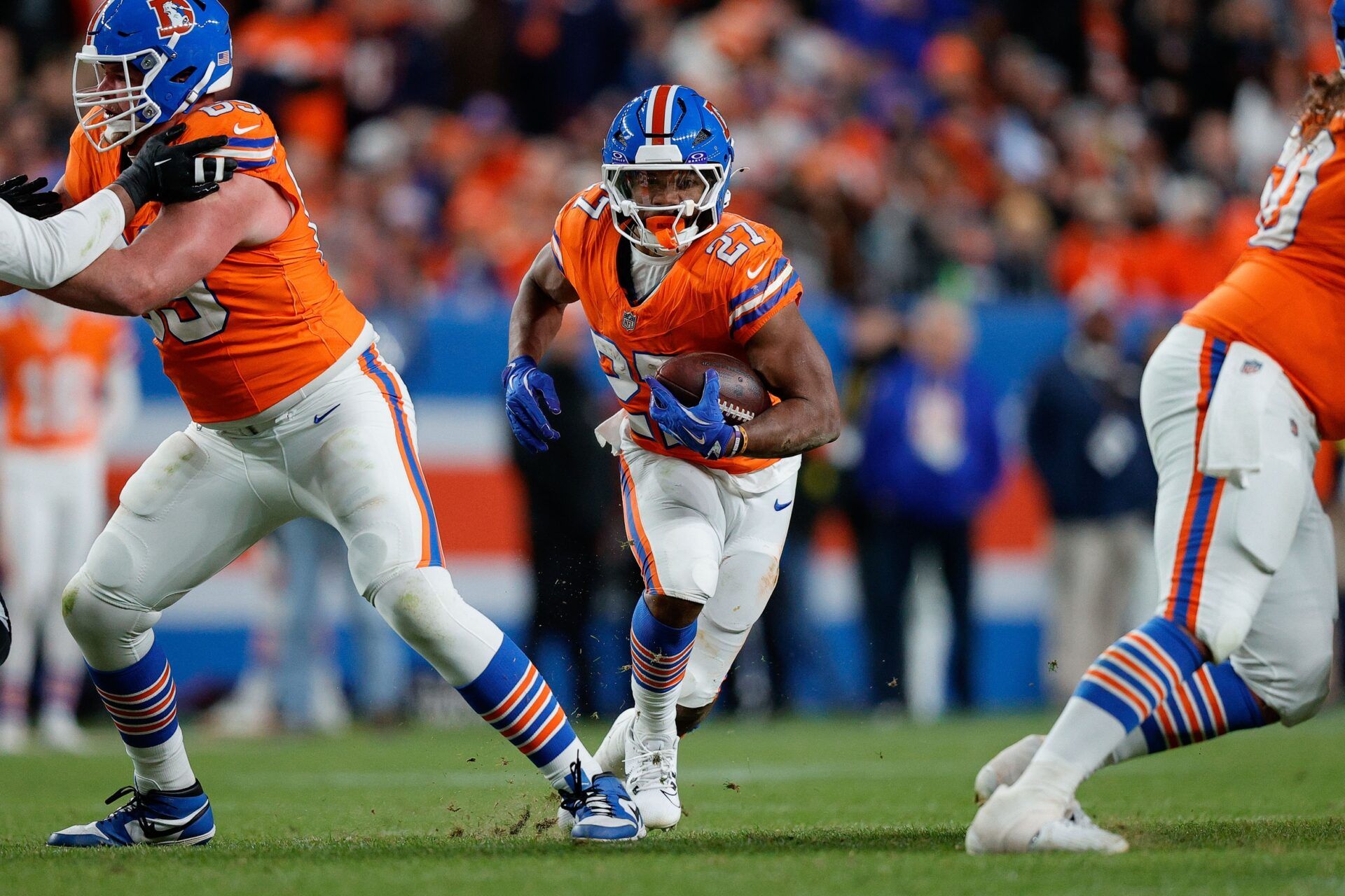 Denver Broncos running back J.K. Dobbins (27) runs the ball in the fourth quarter against the Las Vegas Raiders at Empower Field at Mile High.