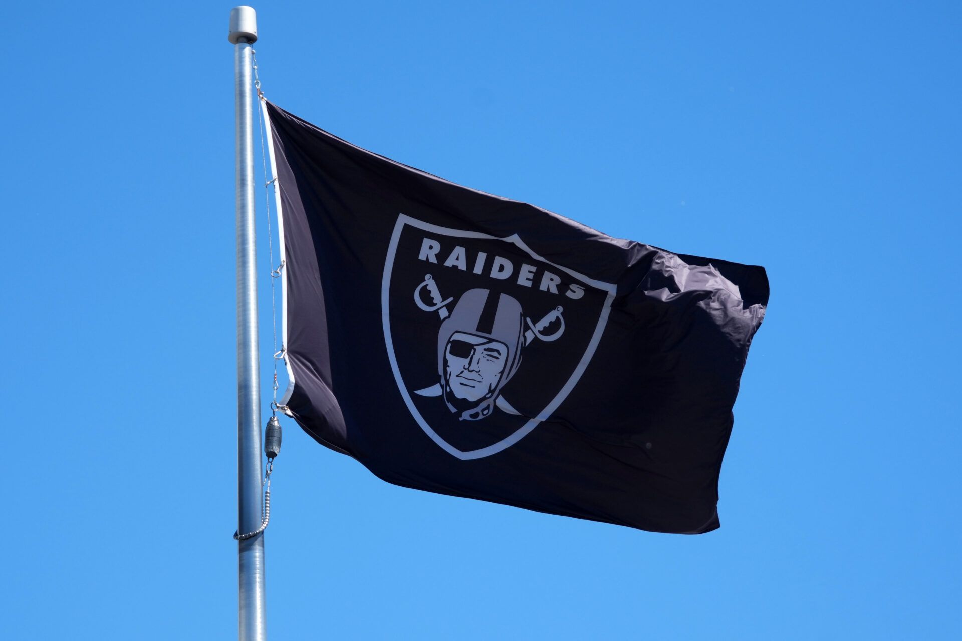 A Las Vegas Raiders shield logo flag at the Intermountain Healthcare Performance Center.