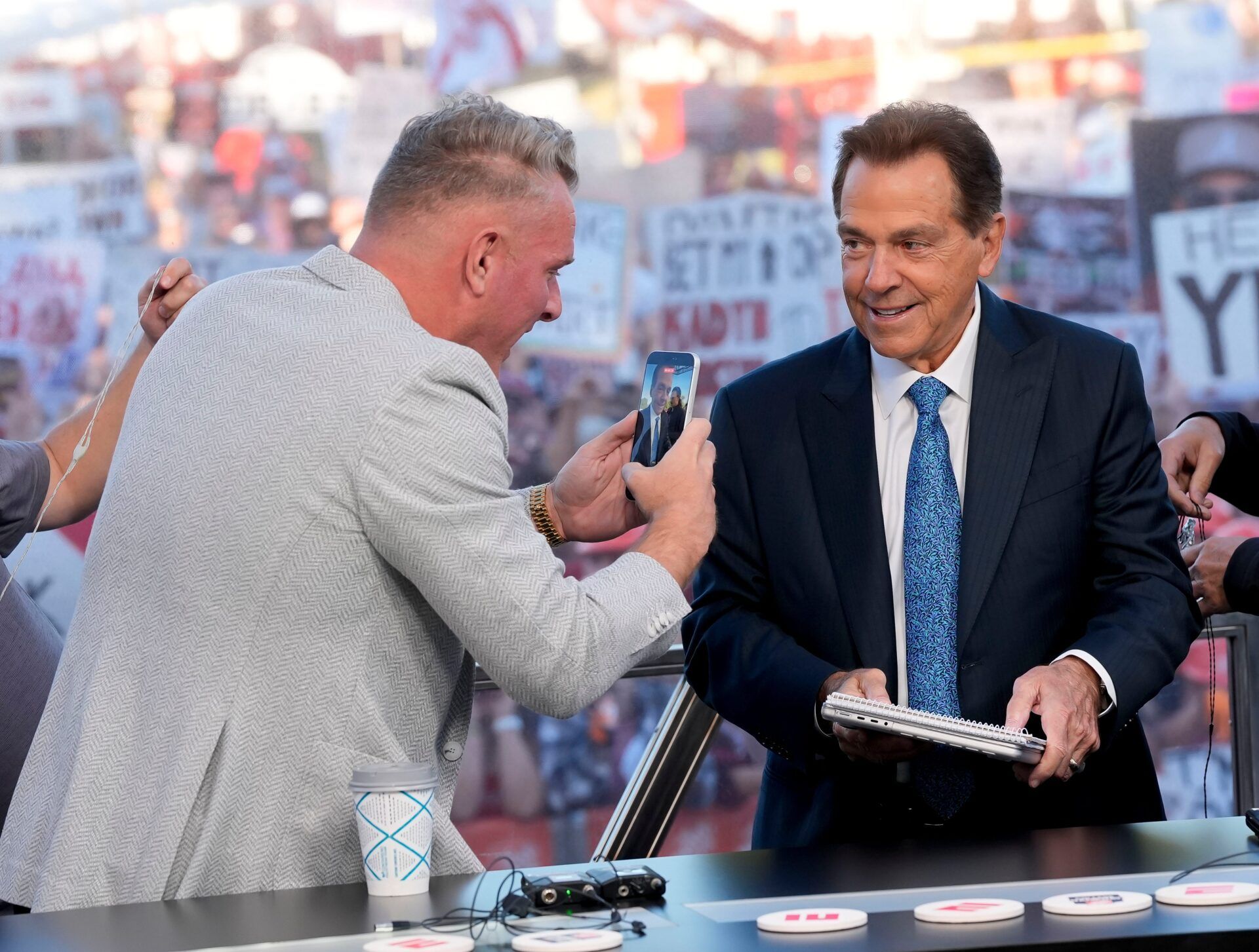 Oct. 4, 2025; Tuscaloosa, Alabama, USA; Pat McAfee takes a cell phone video of former Alabama head coach Nick Saban, now a co-host of the ESPN College GameDay show, as he comes on set on location on the Quad at the University of Alabama before the Alabama versus Vanderbilt game.