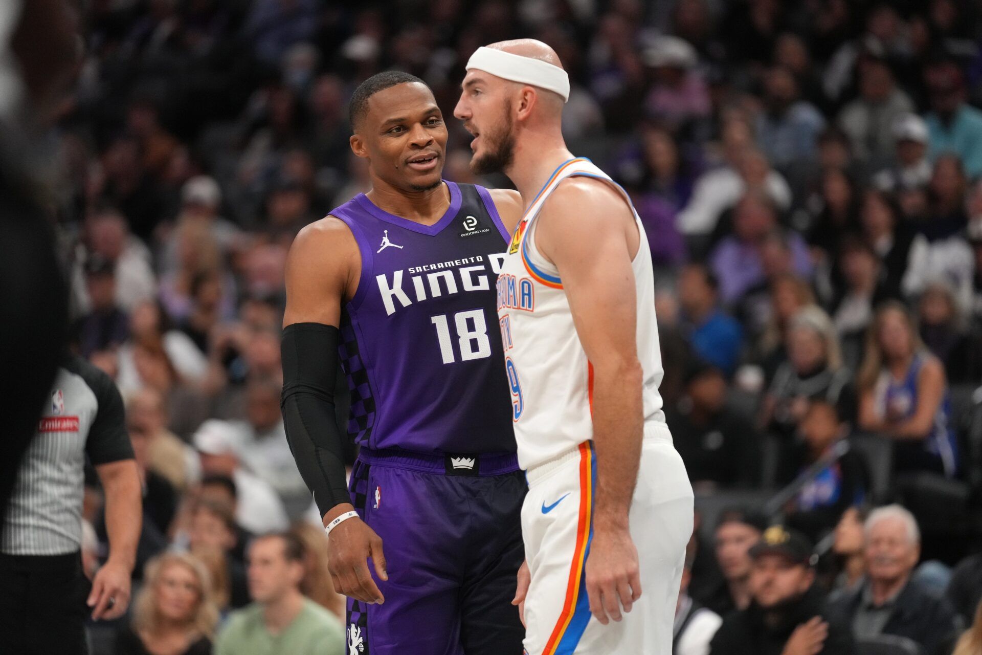 Sacramento Kings guard Russell Westbrook (18) talks with Oklahoma City Thunder guard Alex Caruso (9) during a break in the action in the second quarter at the Golden 1 Center.