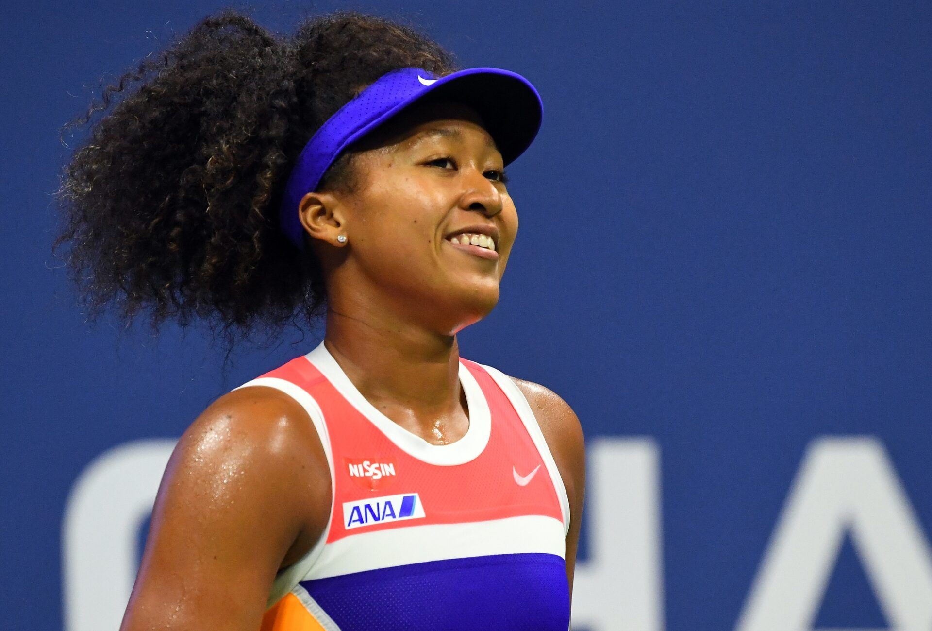 Naomi Osaka of Japan smiles between serves against Jennifer Brady of the United States in the women's singles semifinals match on day eleven of the 2020 U.S. Open tennis tournament at USTA Billie Jean King National Tennis Center.