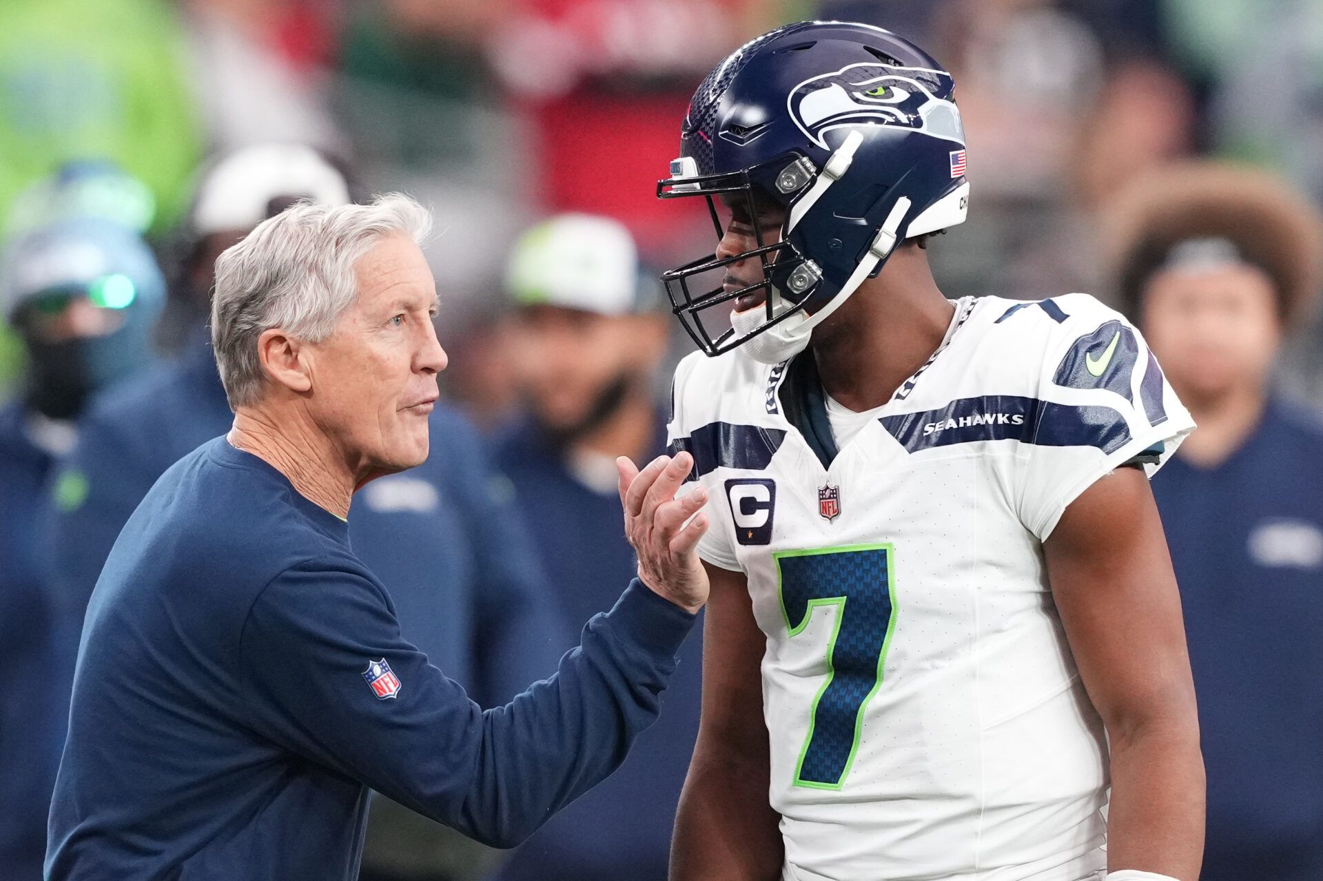 Seattle Seahawks head coach Pete Carroll talks with Seattle Seahawks quarterback Geno Smith (7) during the first half of the game against the Arizona Cardinals at State Farm Stadium.