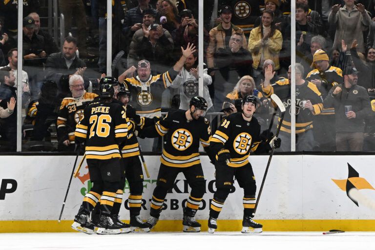 Boston Bruins center Sean Kuraly (52) celebrates with teammates after scoring a goal against the Ottawa Senators during the second period at the TD Garden.