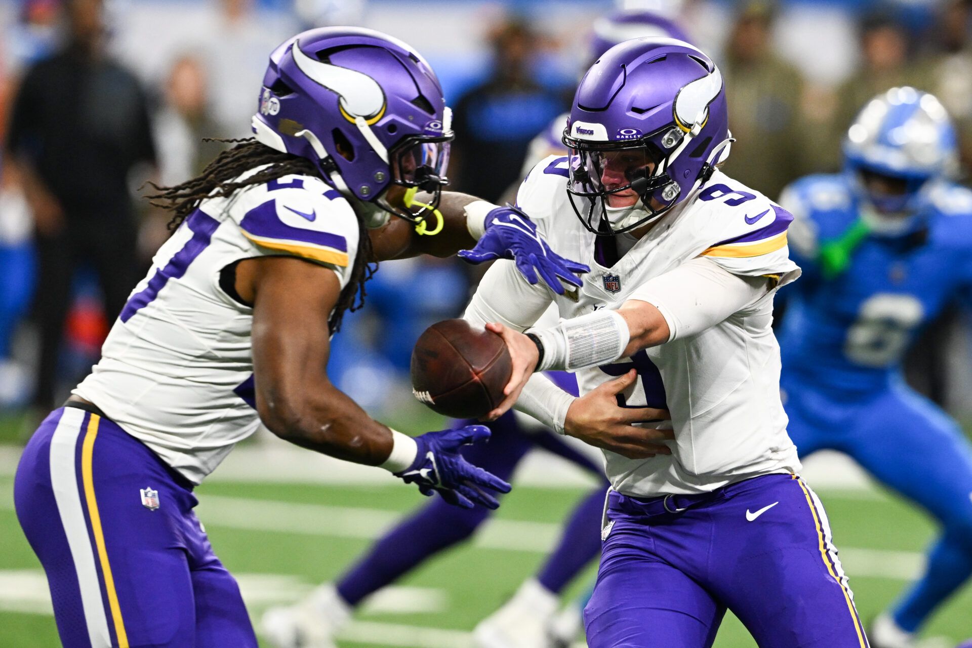 Minnesota Vikings quarterback J.J. McCarthy (9) hands the ball off to  running back Jordan Mason (27) in the first quarter against the Detroit Lions at Ford Field.