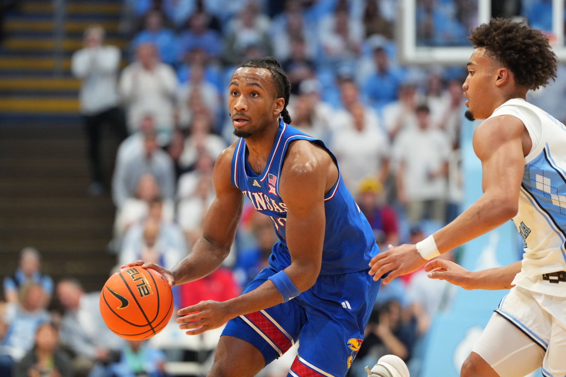 Kansas Jayhawks guard Darryn Peterson (22) dribbles as North Carolina Tar Heels guard Seth Trimble (7) defends in the first half at Dean E. Smith Center.