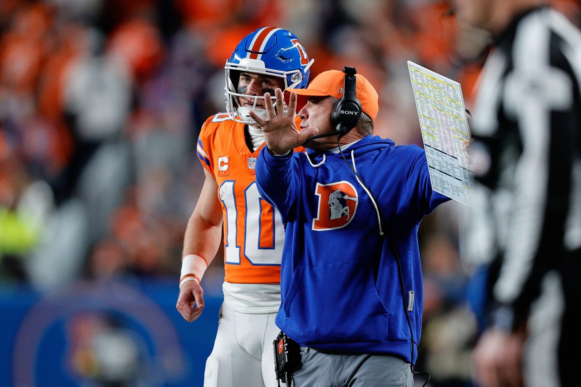 Denver Broncos quarterback Bo Nix (10) talks with head coach Sean Payton in the fourth quarter against the Las Vegas Raiders at Empower Field at Mile High.