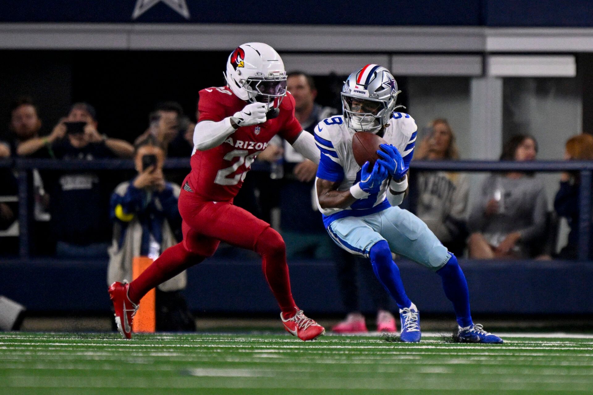 Dallas Cowboys wide receiver George Pickens (3) catches a pass in front of Arizona Cardinals cornerback Denzel Burke (29) during the game between the Dallas Cowboys and the Arizona Cardinals at AT&T Stadium.