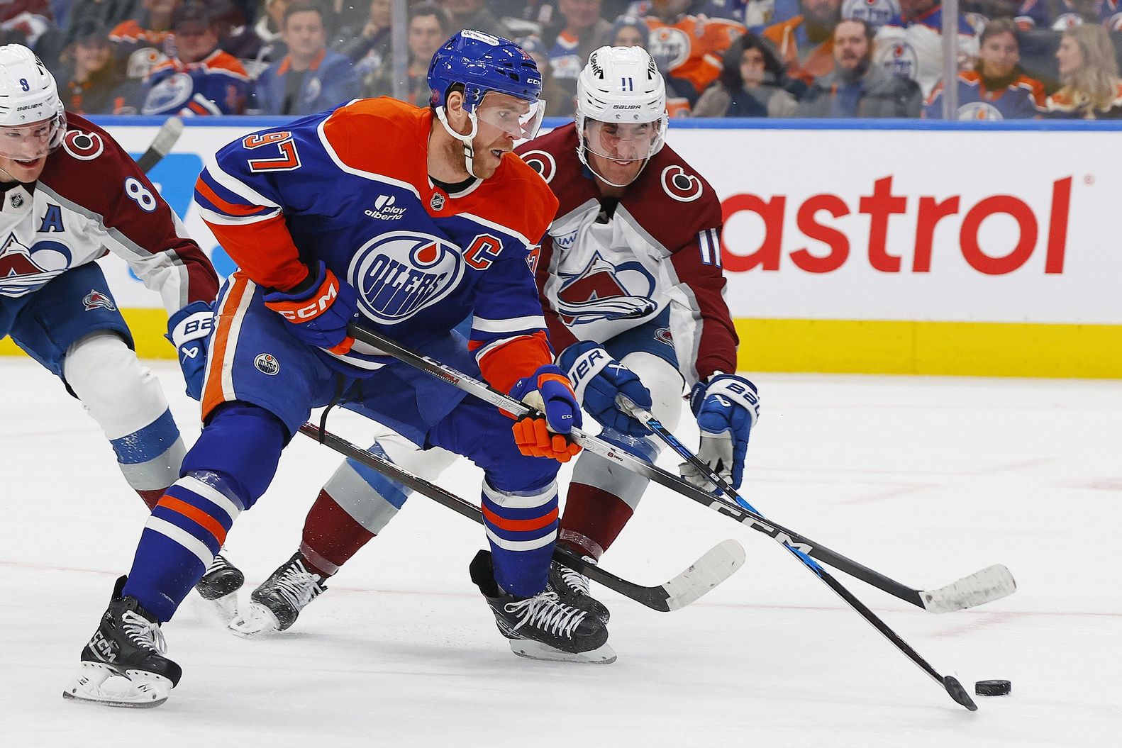 Colorado Avalanche forward Brock Nelson (11) tries to knock the puck away from Edmonton Oilers forward Connor McDavid (97) during the third period at Rogers Place.