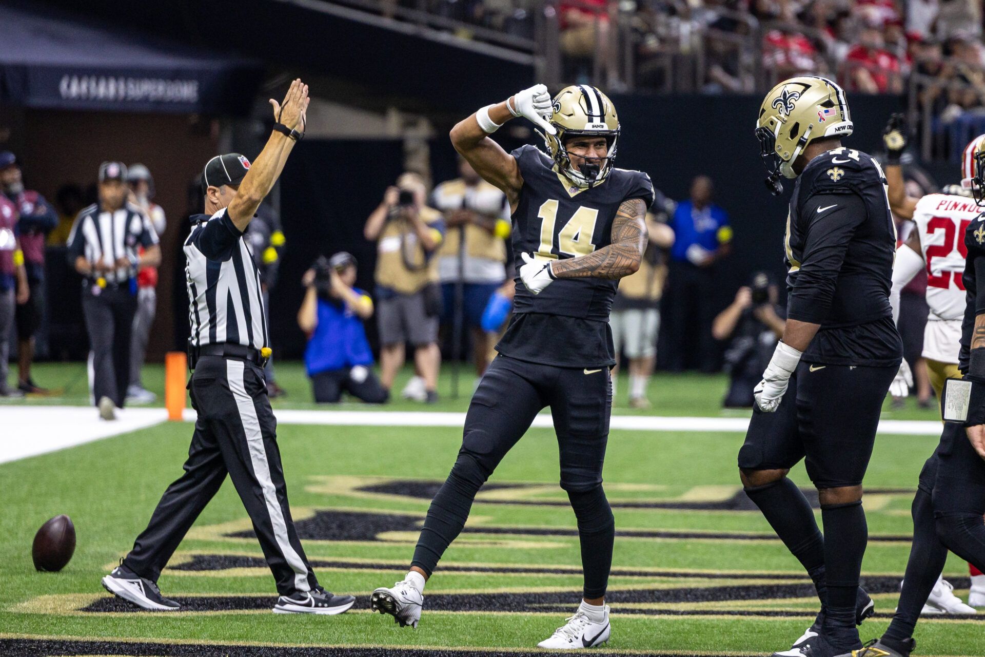 New Orleans Saints wide receiver Devaughn Vele (14) reacts to scoring a touchdown against San Francisco 49ers safety Jason Pinnock (25) during the second half at Caesars Superdome.