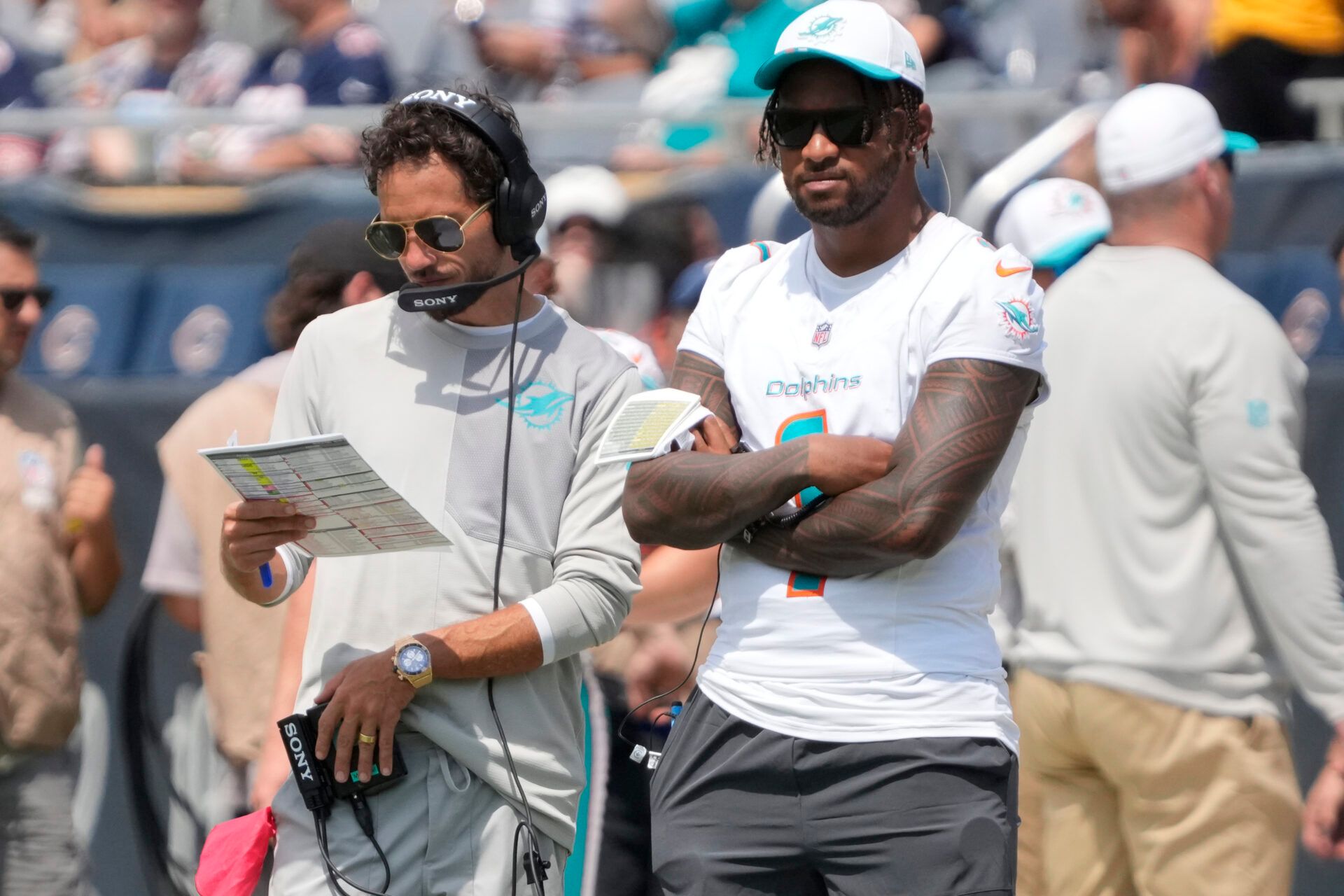 Miami Dolphins head coach Mike McDaniels with quarterback Tua Tagovailoa (1) on thee sidelines during the second half of a game against the Chicago Bears at Soldier Field.
