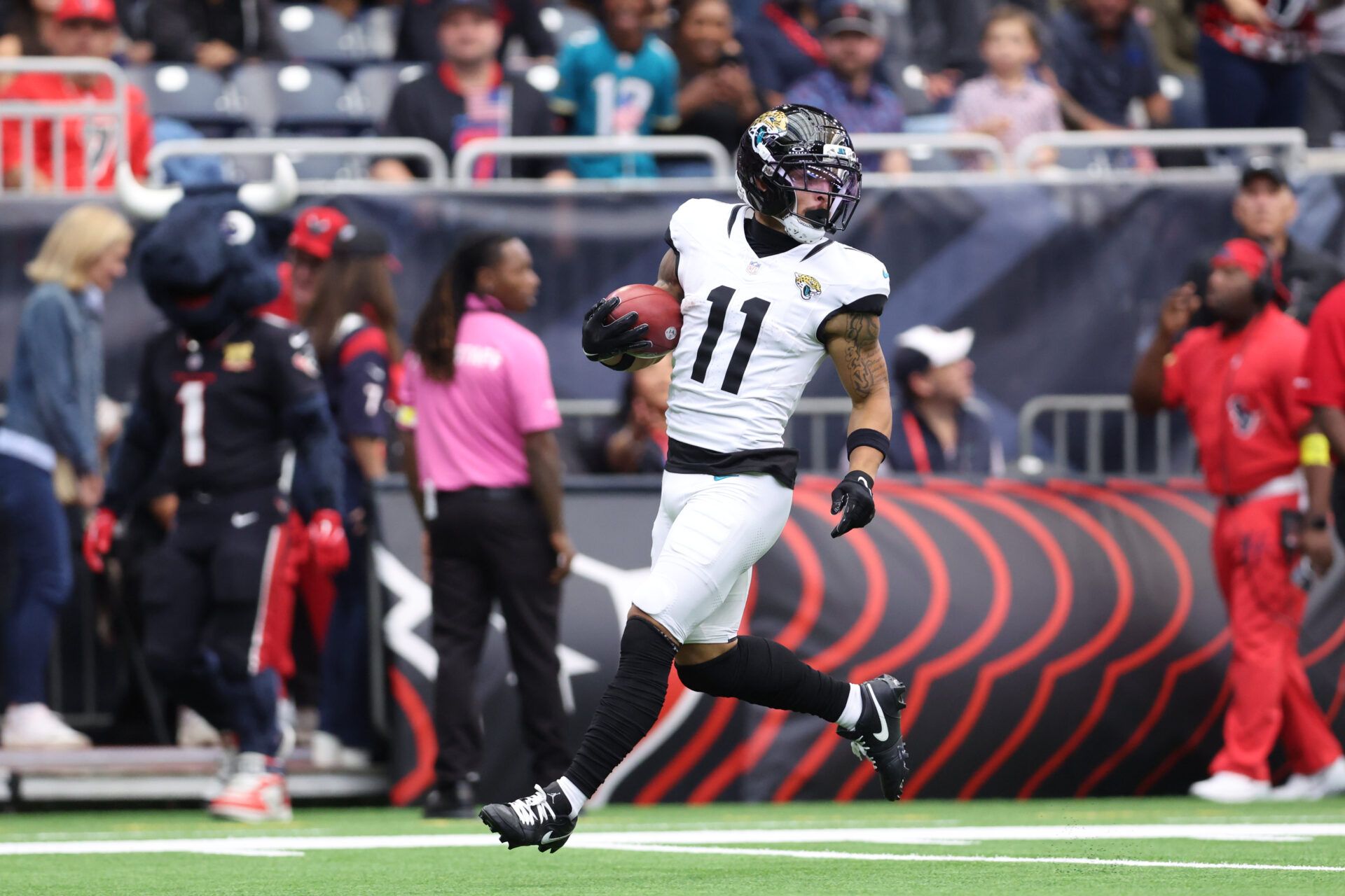 Jacksonville Jaguars wide receiver Parker Washington (11) returns a punt for a touchdown against the Houston Texans during the first half at NRG Stadium.