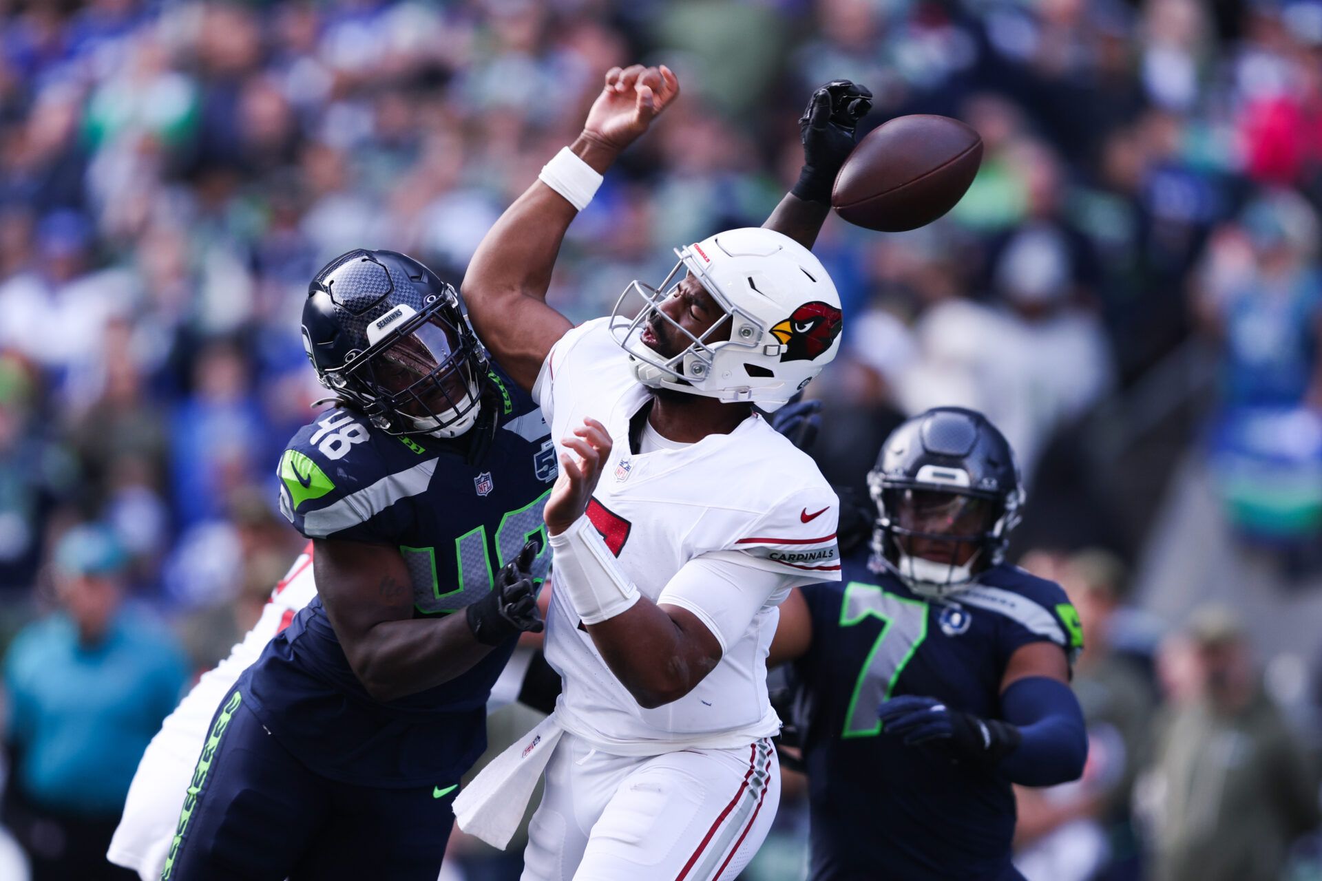 Arizona Cardinals quarterback Jacoby Brissett (7) fumbles the ball as Seattle Seahawks linebacker Tyrice Knight (48) defends during the second quarter at Lumen Field.