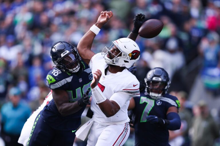 Arizona Cardinals quarterback Jacoby Brissett (7) fumbles the ball as Seattle Seahawks linebacker Tyrice Knight (48) defends during the second quarter at Lumen Field.