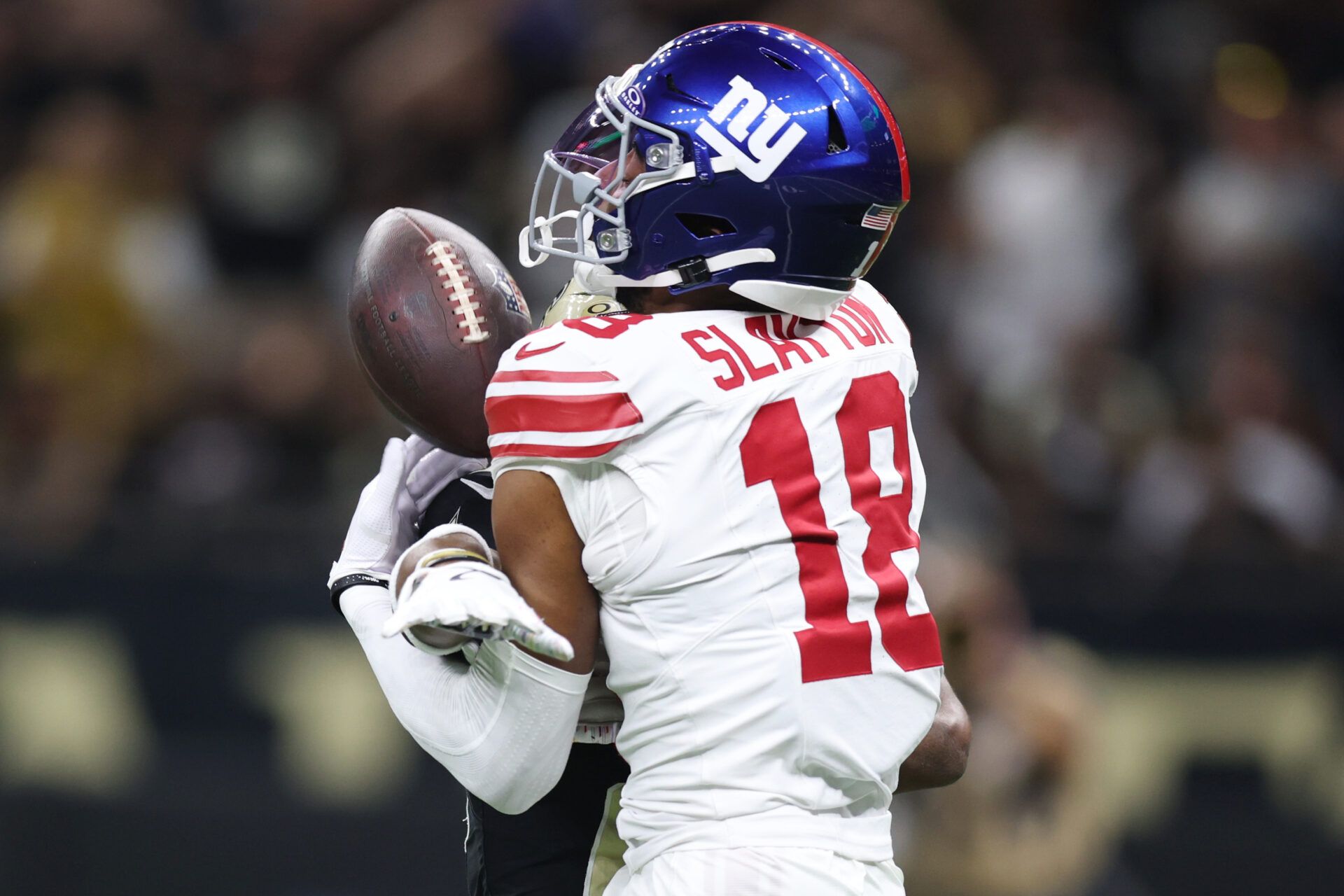 New York Giants wide receiver Darius Slayton (18) reaches for the ball against New Orleans Saints cornerback Isaac Yiadom (26) during the first half at Caesars Superdome.