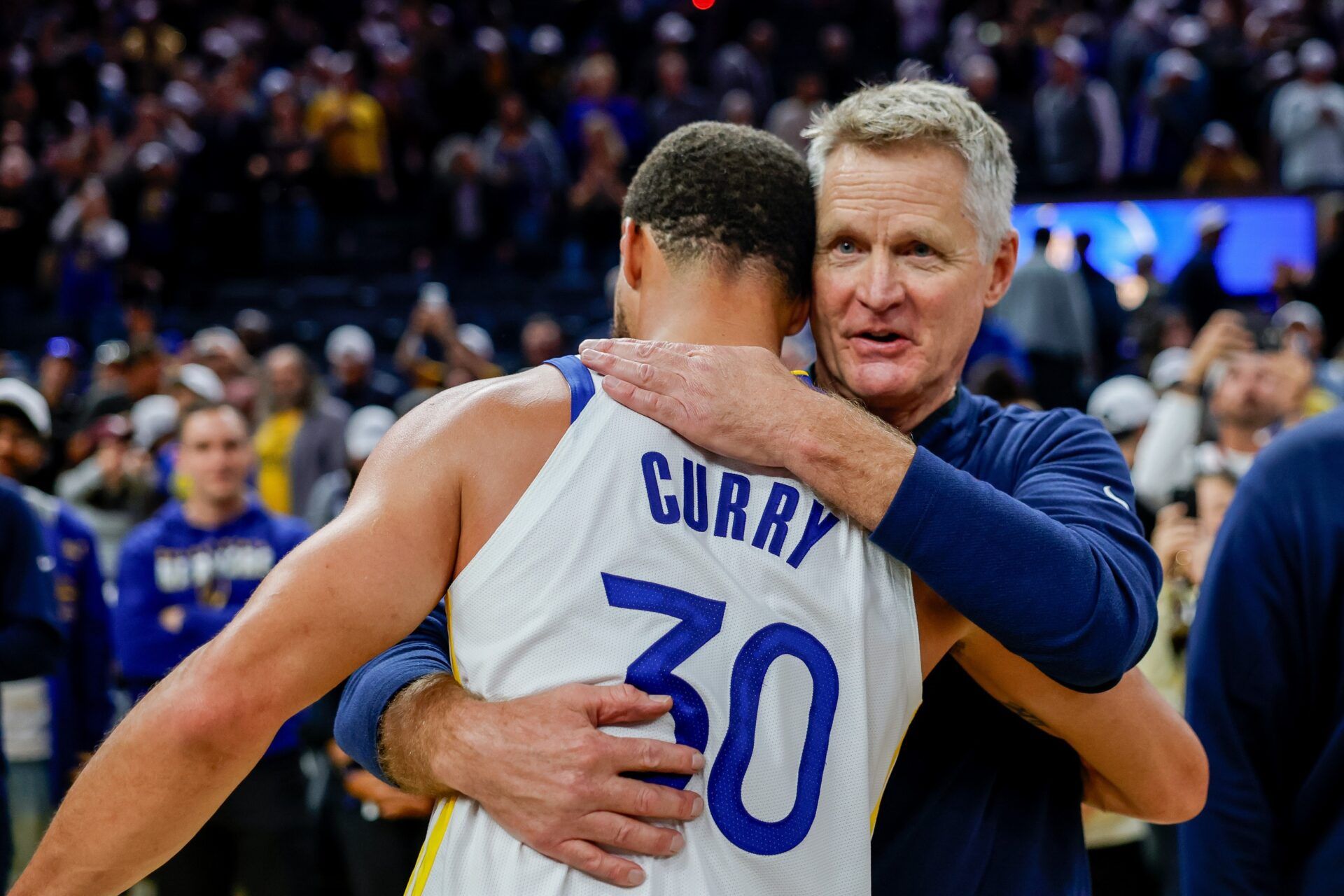 Golden State Warriors guard Stephen Curry (30) embraces head coach Steve Kerr after their overtime win against the Denver Nuggets at Chase Center.