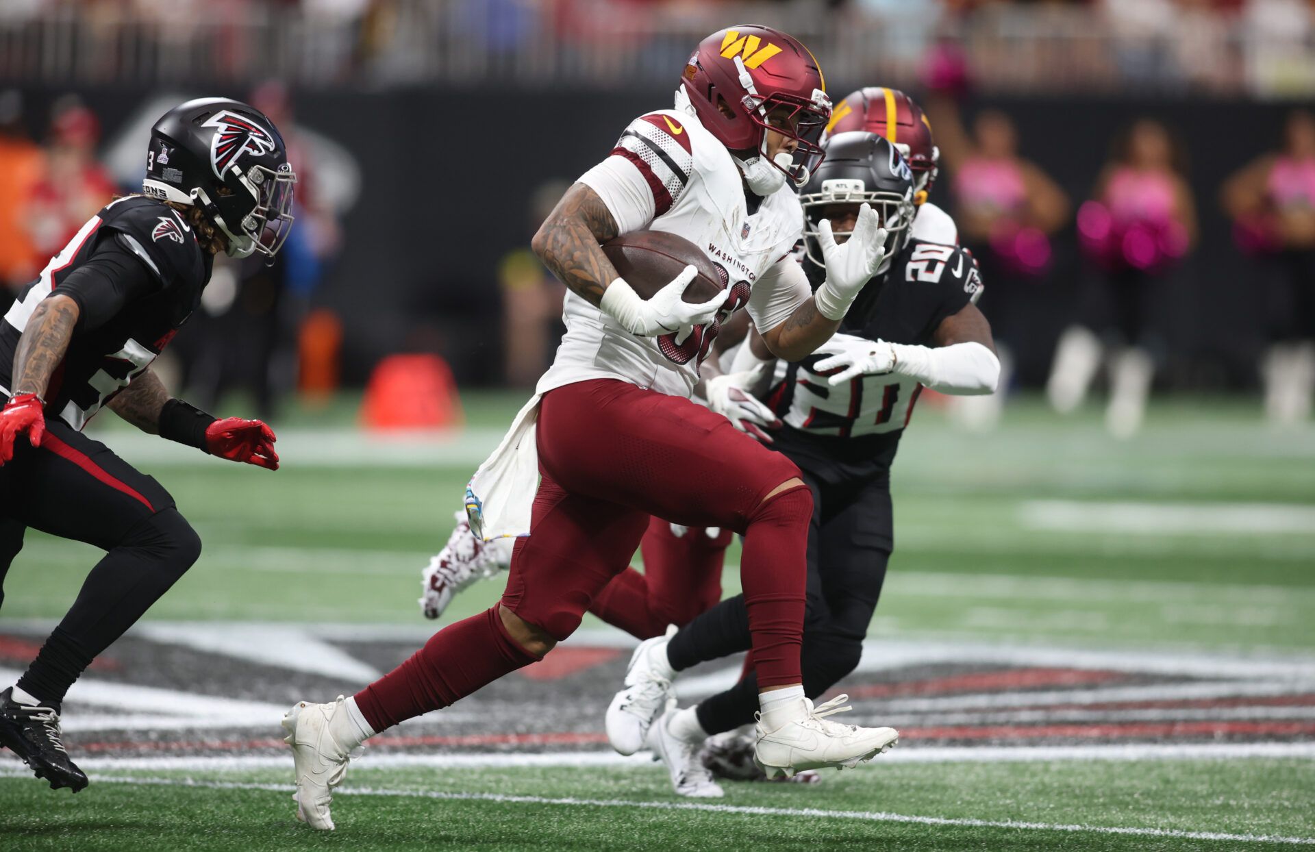 Washington Commanders running back Chris Rodriguez Jr. (36) runs against Atlanta Falcons cornerback Dee Alford (20) during the first half at Mercedes-Benz Stadium.