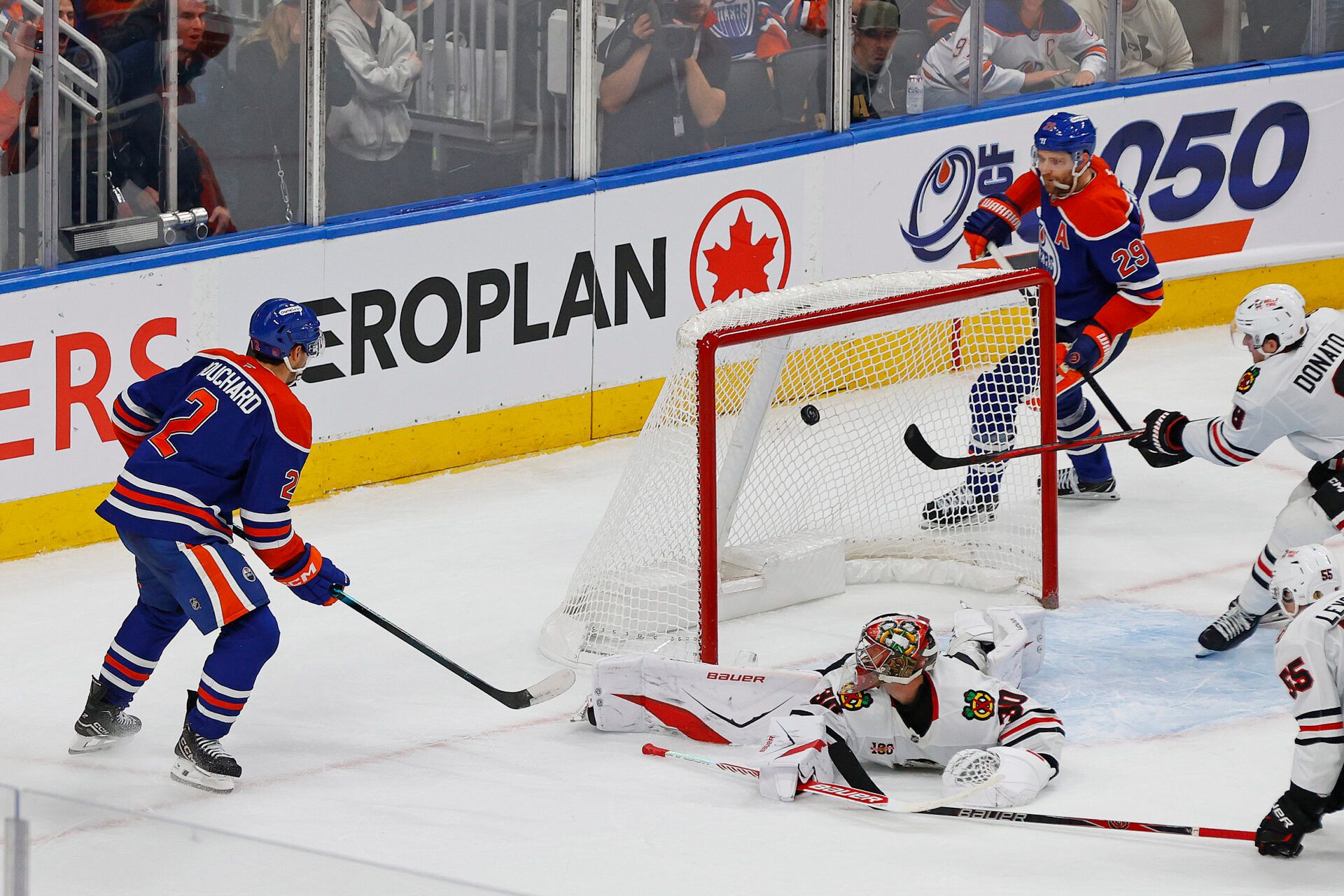 Edmonton Oilers defensemen Evan Bouchard (2) scores the game winning goal during overtime against the Chicago Blackhawks at Rogers Place.