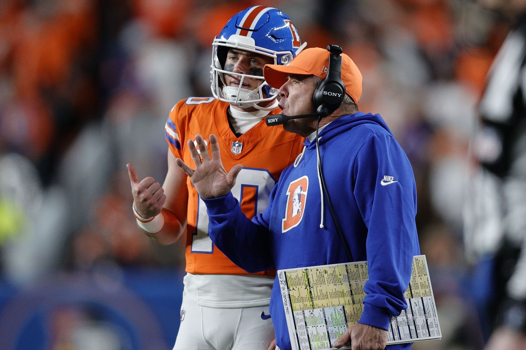 Denver Broncos head coach Sean Payton talks with quarterback Bo Nix (10) during the second half at Empower Field at Mile High.