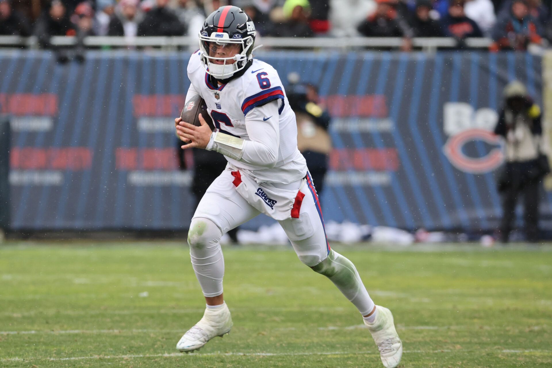 New York Giants quarterback Jaxson Dart (6) rushes the ball against the Chicago Bears during the second half at Soldier Field.