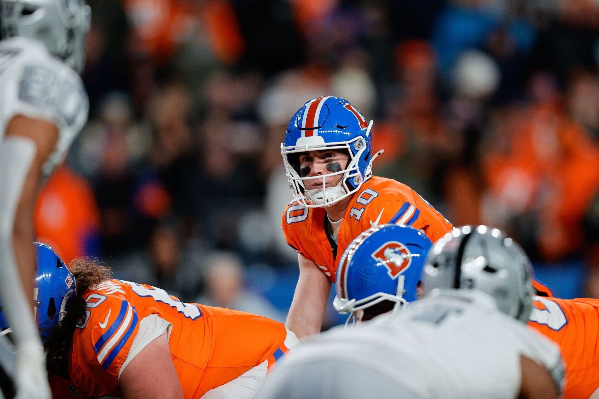 Denver Broncos quarterback Bo Nix (10) at the line of scrimmage in the fourth quarter aLas Vegas Raiders at Empower Field at Mile High.