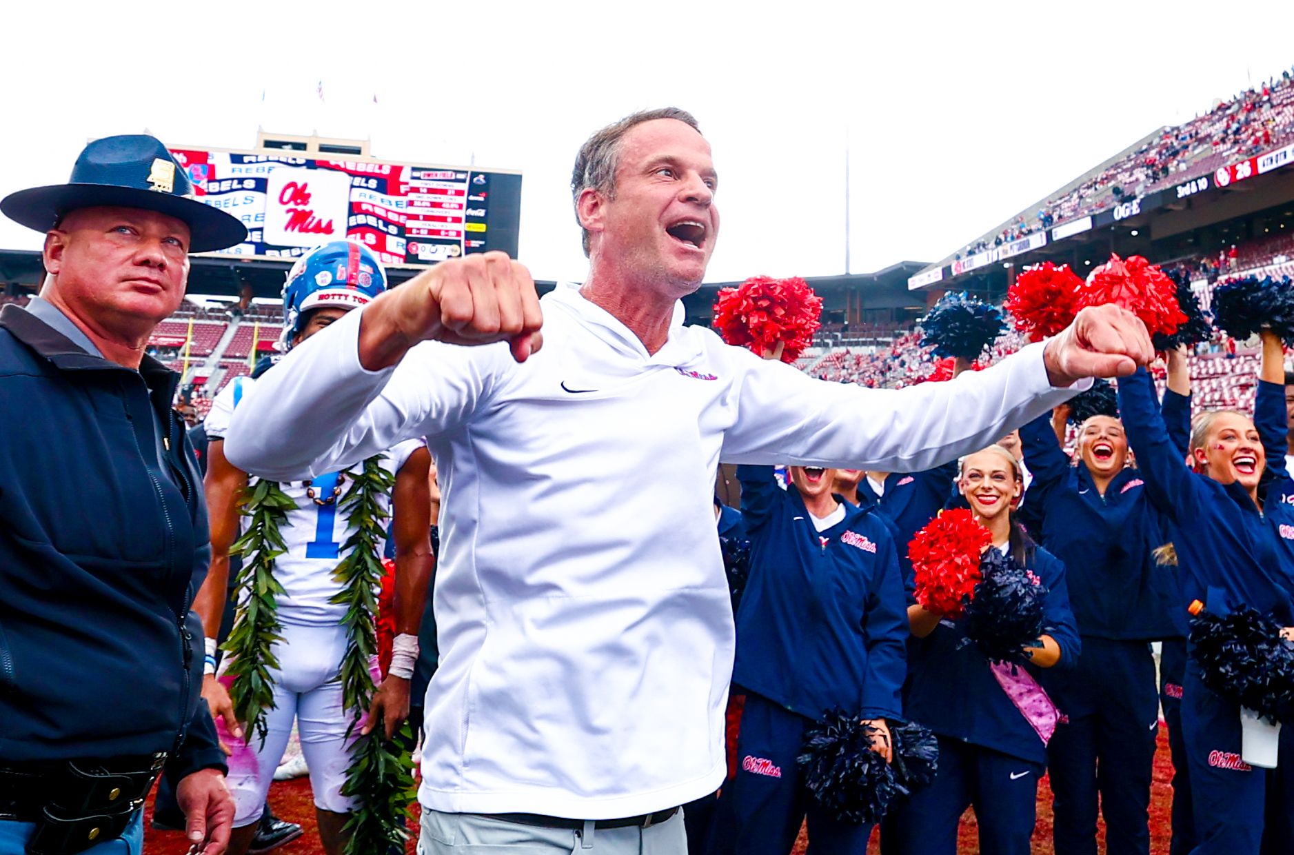 Ole Miss Rebels head coach Lane Kiffin celebrates with fans after the game against the Oklahoma Sooners at Gaylord Family-Oklahoma Memorial Stadium.