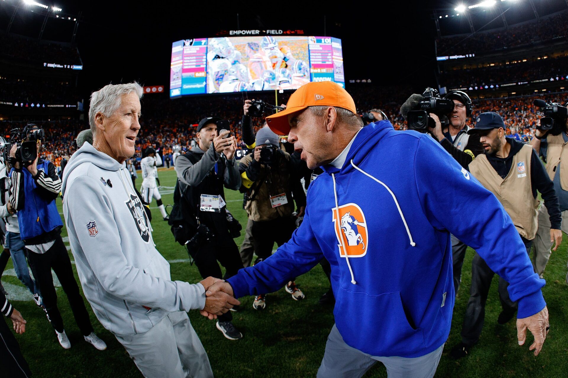 Denver Broncos head coach Sean Payton greets Las Vegas Raiders head coach Pete Carrolla after the game at Empower Field at Mile High.