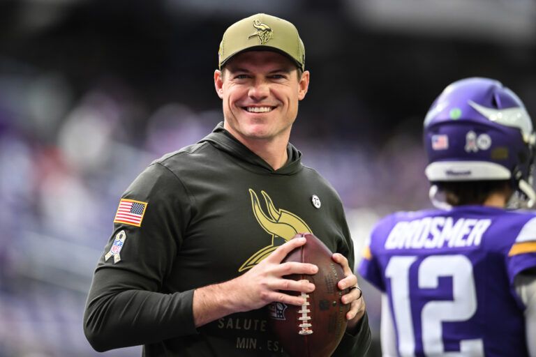 Minnesota Vikings head coach Kevin O'Connell warms up with his team before the game against the Baltimore Ravens at U.S. Bank Stadium.