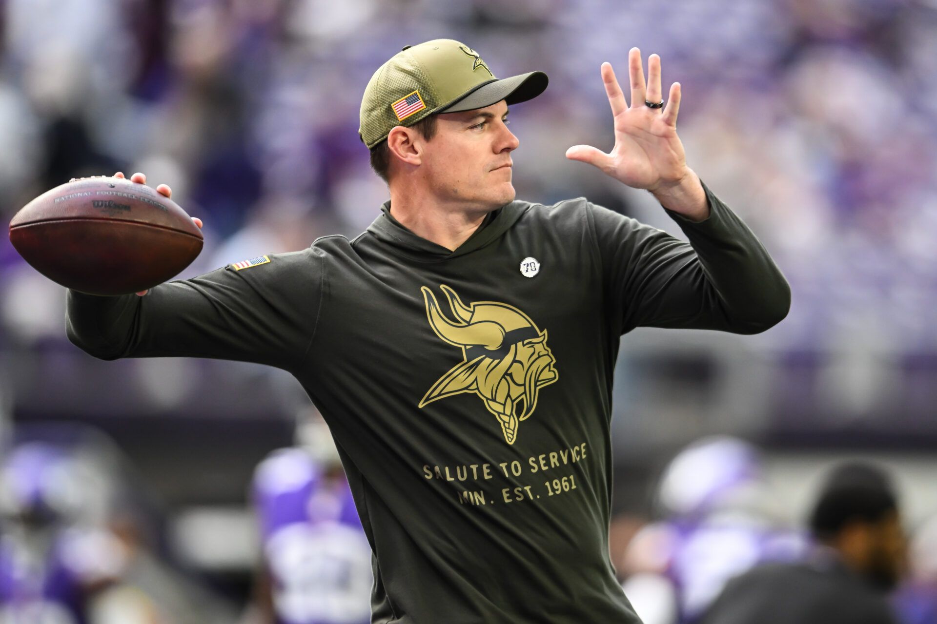 Minnesota Vikings head coach Kevin O'Connell warms up with his team before the game against the Baltimore Ravens at U.S. Bank Stadium.