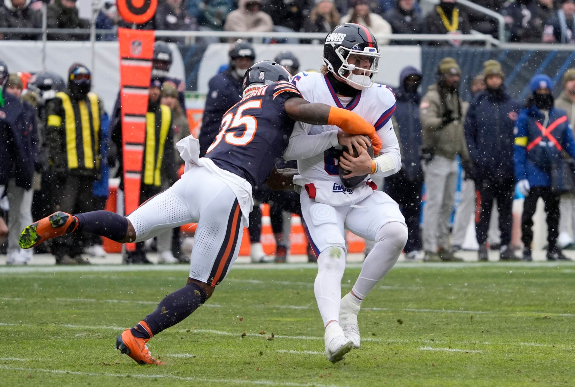 Chicago Bears safety C.J. Gardner-Johnson (35) sacks New York Giants quarterback Jaxson Dart (6) during the first half at Soldier Field.
