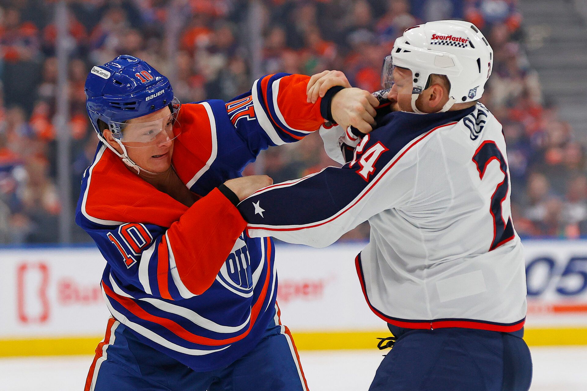 Edmonton Oilers forward Trent Frederic (10) and Columbus Blue Jackets forward Mathieu Olivier (24) during the first period at Rogers Place.