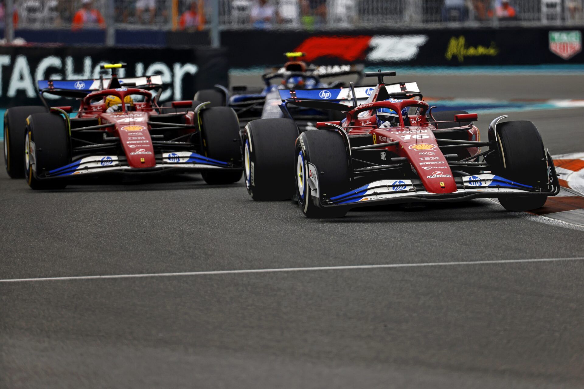 Ferrari driver Charles Leclerc (16) passes Ferrari driver Lewis Hamilton (44) and Williams driver Carlos Sainz (55) during the F1 Miami Grand Prix at Miami International Autodrome.