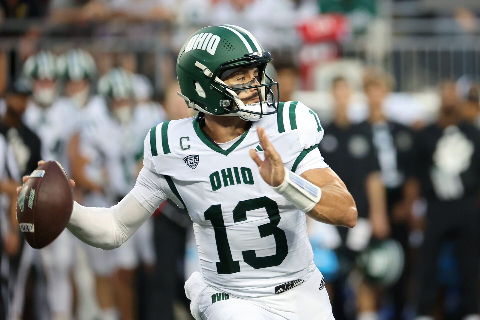 Ohio Bobcats quarterback Parker Navarro (13) drops back to pass during the first quarter against the Ohio State Buckeyes at Ohio Stadium.