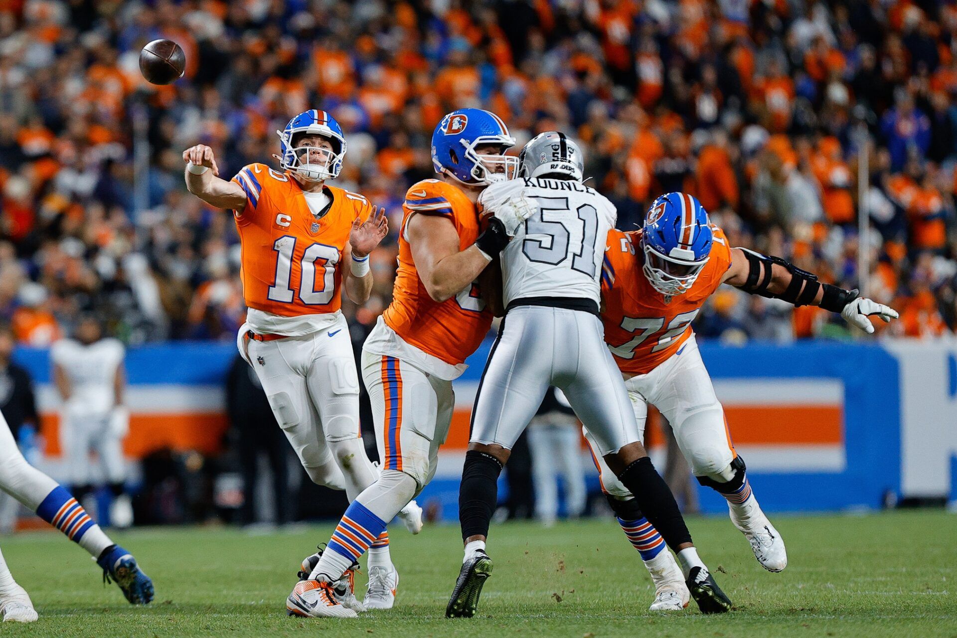 Denver Broncos quarterback Bo Nix (10) attempts a pass as offensive tackle Alex Palczewski (63) and offensive tackle Garett Bolles (72) defend against Las Vegas Raiders defensive end Malcolm Koonce (51) in the fourth quarter at Empower Field at Mile High.