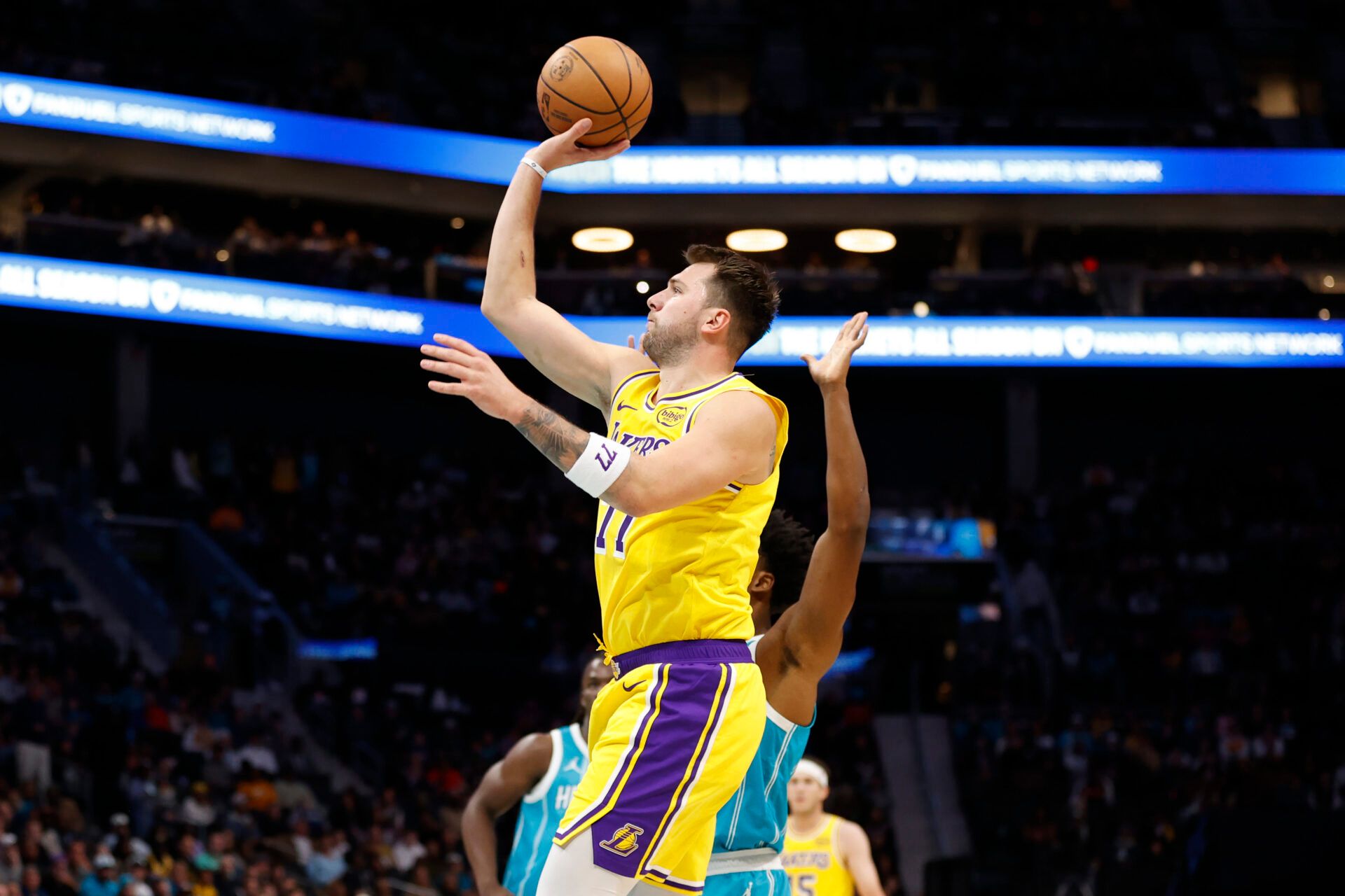 Los Angeles Lakers forward/guard Luka Doncic (77) floats a shot towards the basket during the first quarter against the Charlotte Hornets at Spectrum Center.