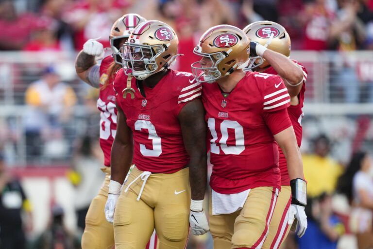 San Francisco 49ers running back Brian Robinson Jr. (3) and San Francisco 49ers quarterback Mac Jones (10) celebrate after a touchdown during the third quarter against the Los Angeles Rams at Levi's Stadium.