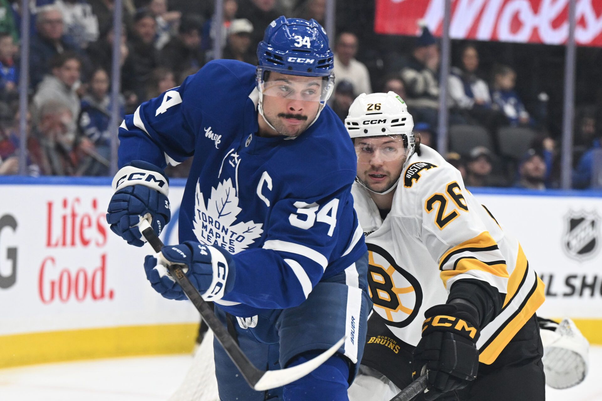Toronto Maple Leafs forward Auston Matthews (34) pursues the puck ahead of Boston Bruins defenseman Andrew Peeke (26) in the first period at Scotiabank Arena.