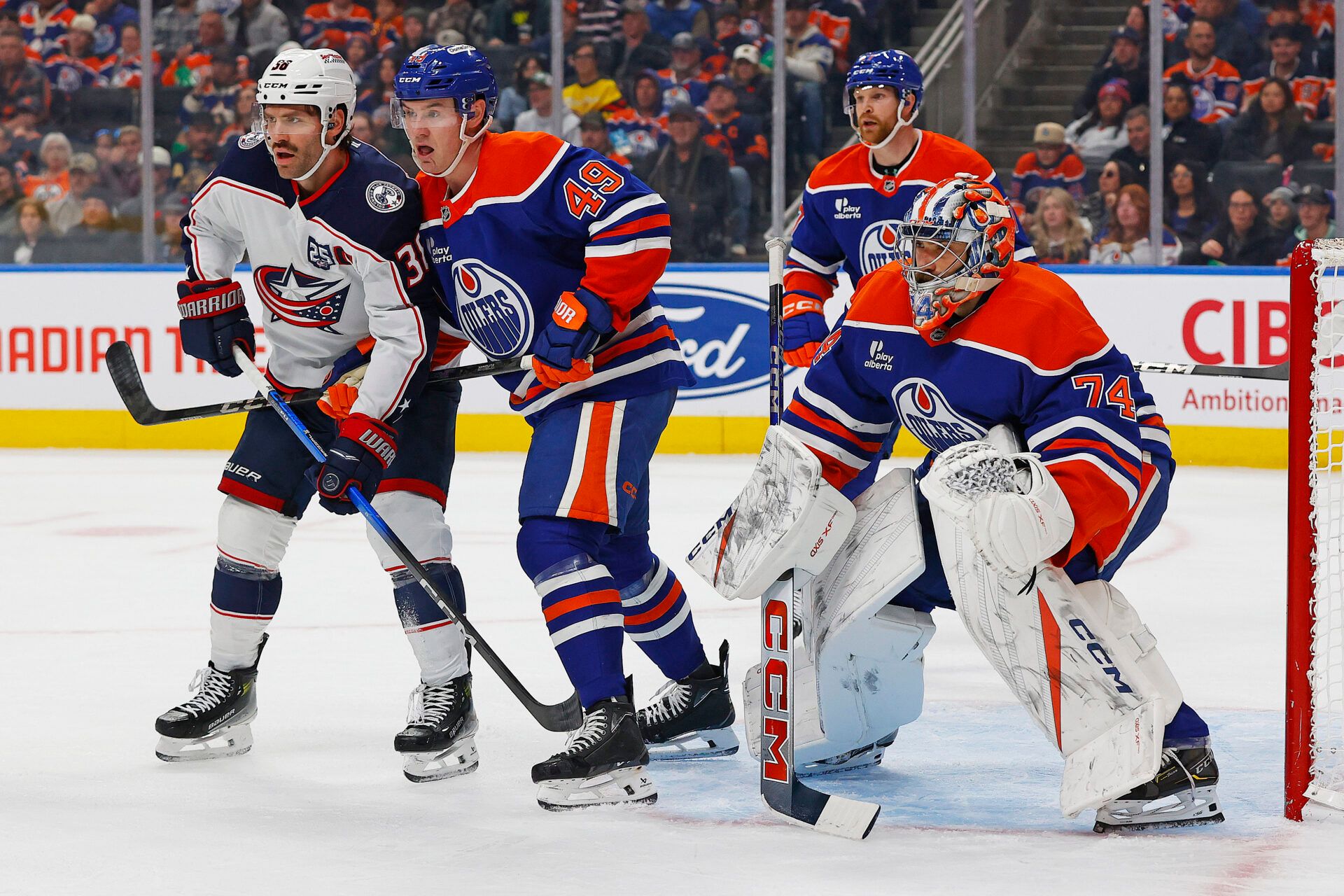 Columbus Blue Jackets forward Boone Jenner (38) battles with Edmonton Oilers defenseman Ty Emberson (49) in front of goaltender Stuart Skinner (74) during the second period at Rogers Place.