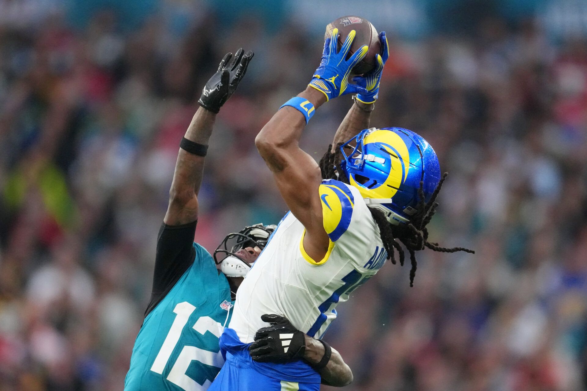 Los Angeles Rams wide receiver Davante Adams (17) makes a catch against Jacksonville Jaguars wide receiver Travis Hunter (12) during the second half of an NFL International Series game at Wembley Stadium.