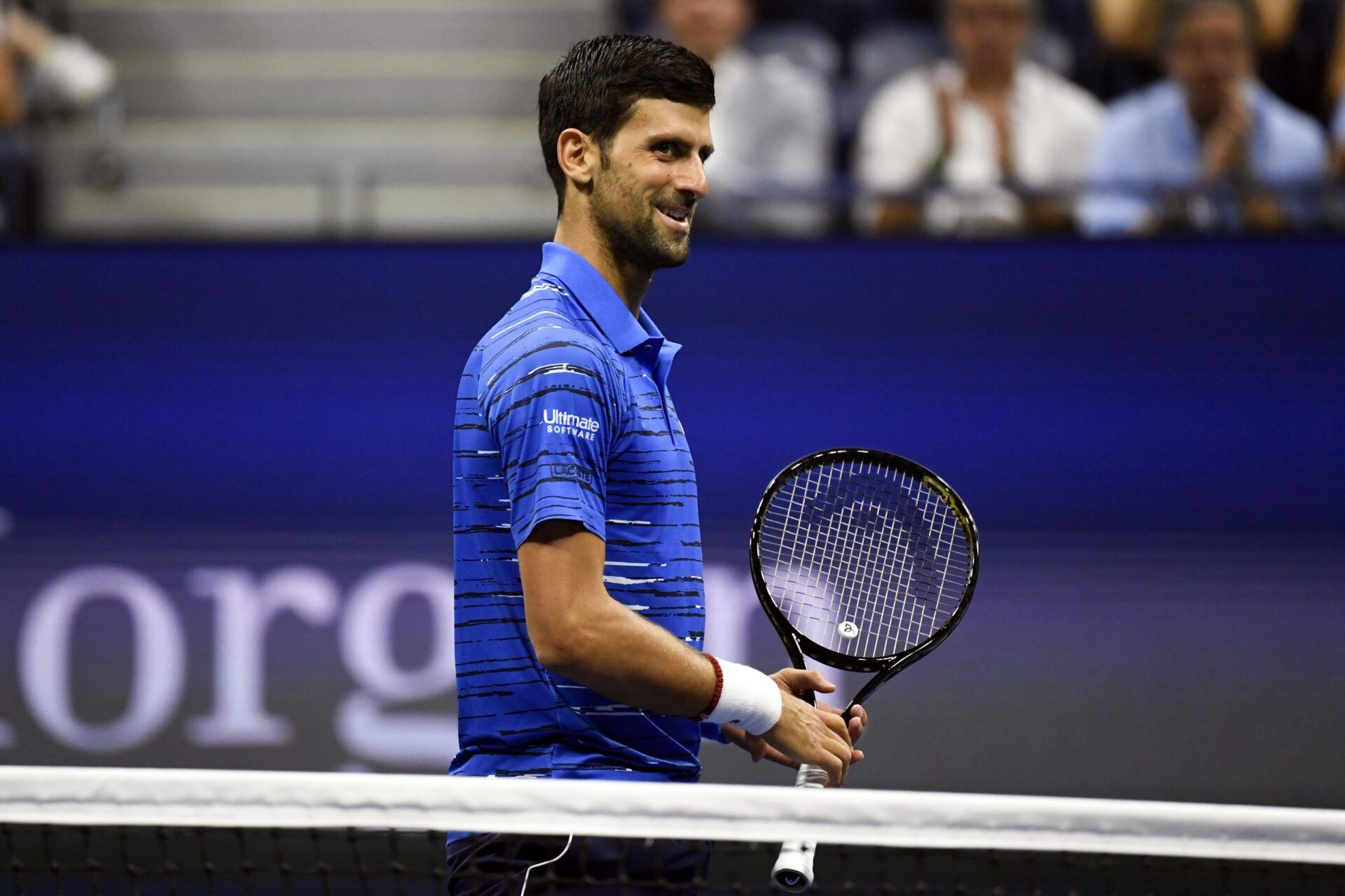 Novak Djokovic of Serbia smiles after missing a shot by Denis Kudla of the United States in the third round on day five of the 2019 U.S. Open tennis tournament at USTA Billie Jean King National Tennis Center.