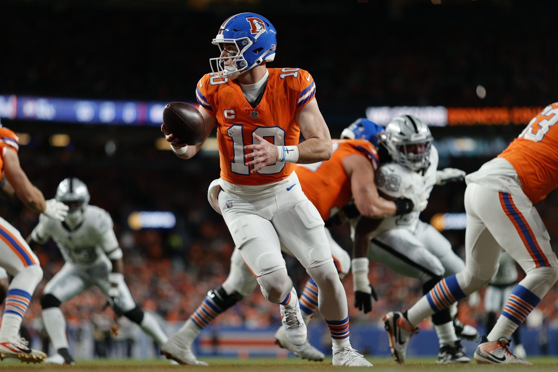 Denver Broncos quarterback Bo Nix (10) drops back to pass against the Las Vegas Raiders during the first half at Empower Field at Mile High.