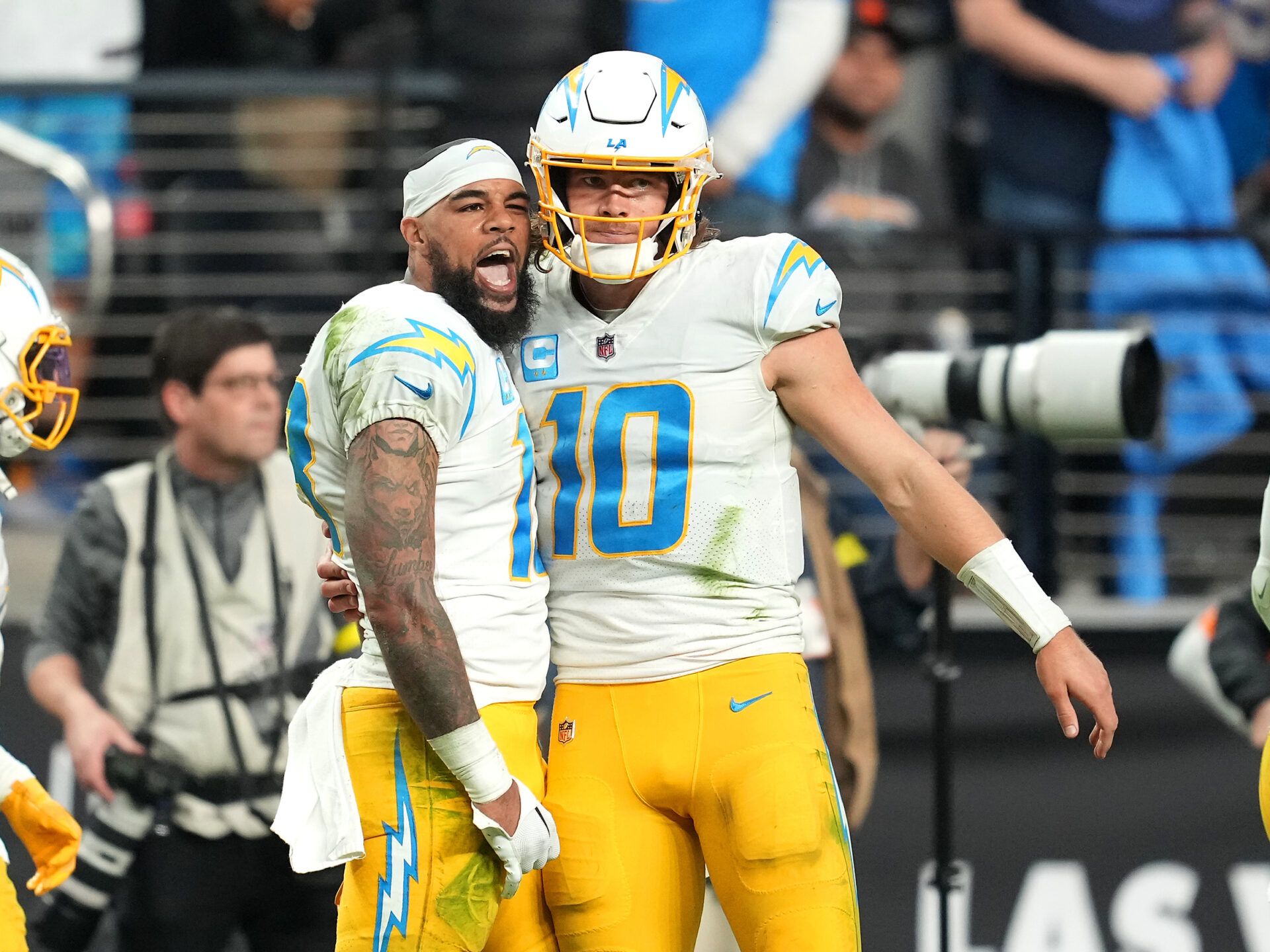 Los Angeles Chargers wide receiver Keenan Allen (13) celebrates with Los Angeles Chargers quarterback Justin Herbert (10) after scoring a touchdown against the Las Vegas Raiders during the second half at Allegiant Stadium.