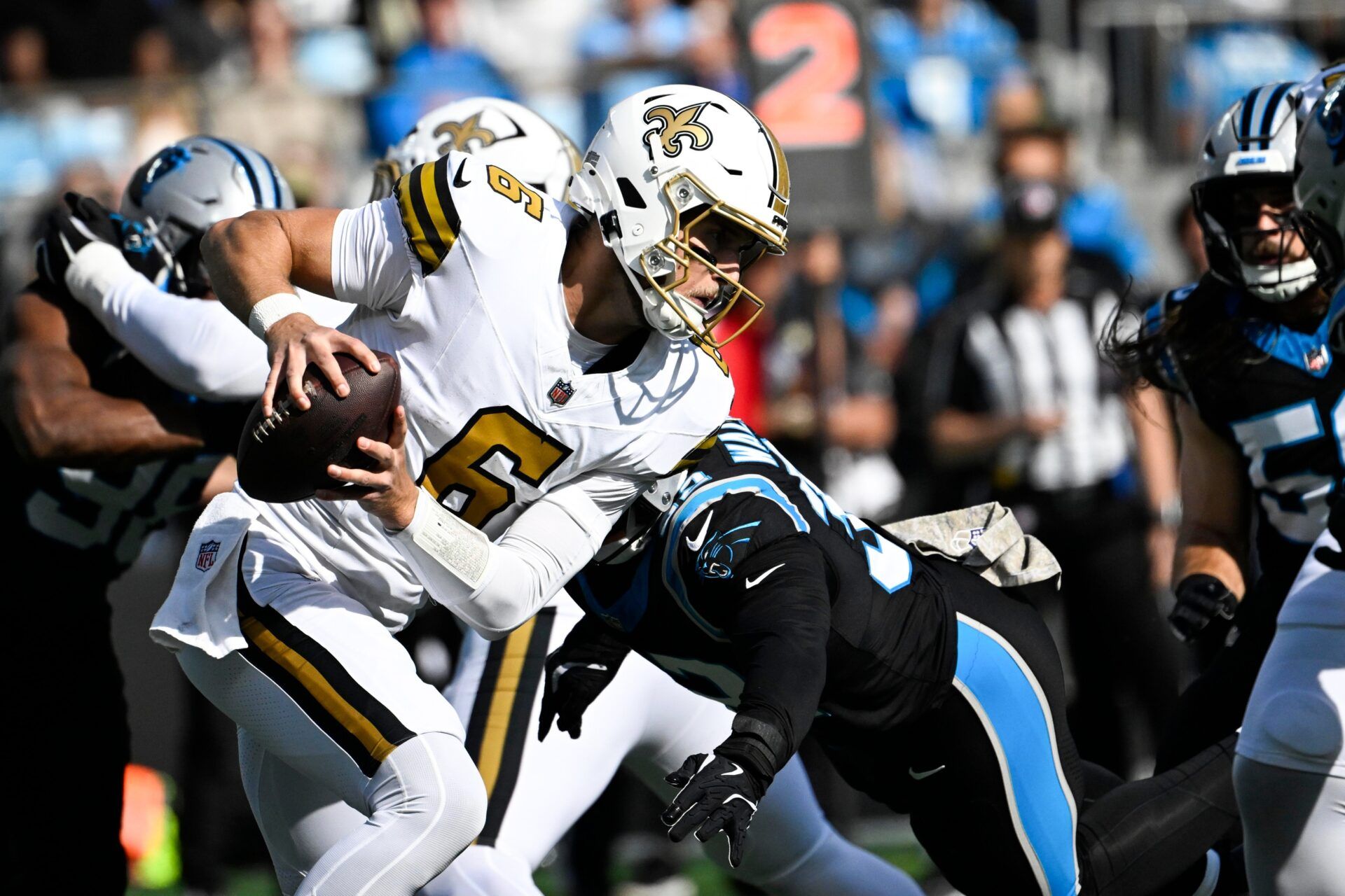 New Orleans Saints quarterback Tyler Shough (6) is sacked by Carolina Panthers linebacker Trevin Wallace (32) in the first quarter at Bank of America Stadium.
