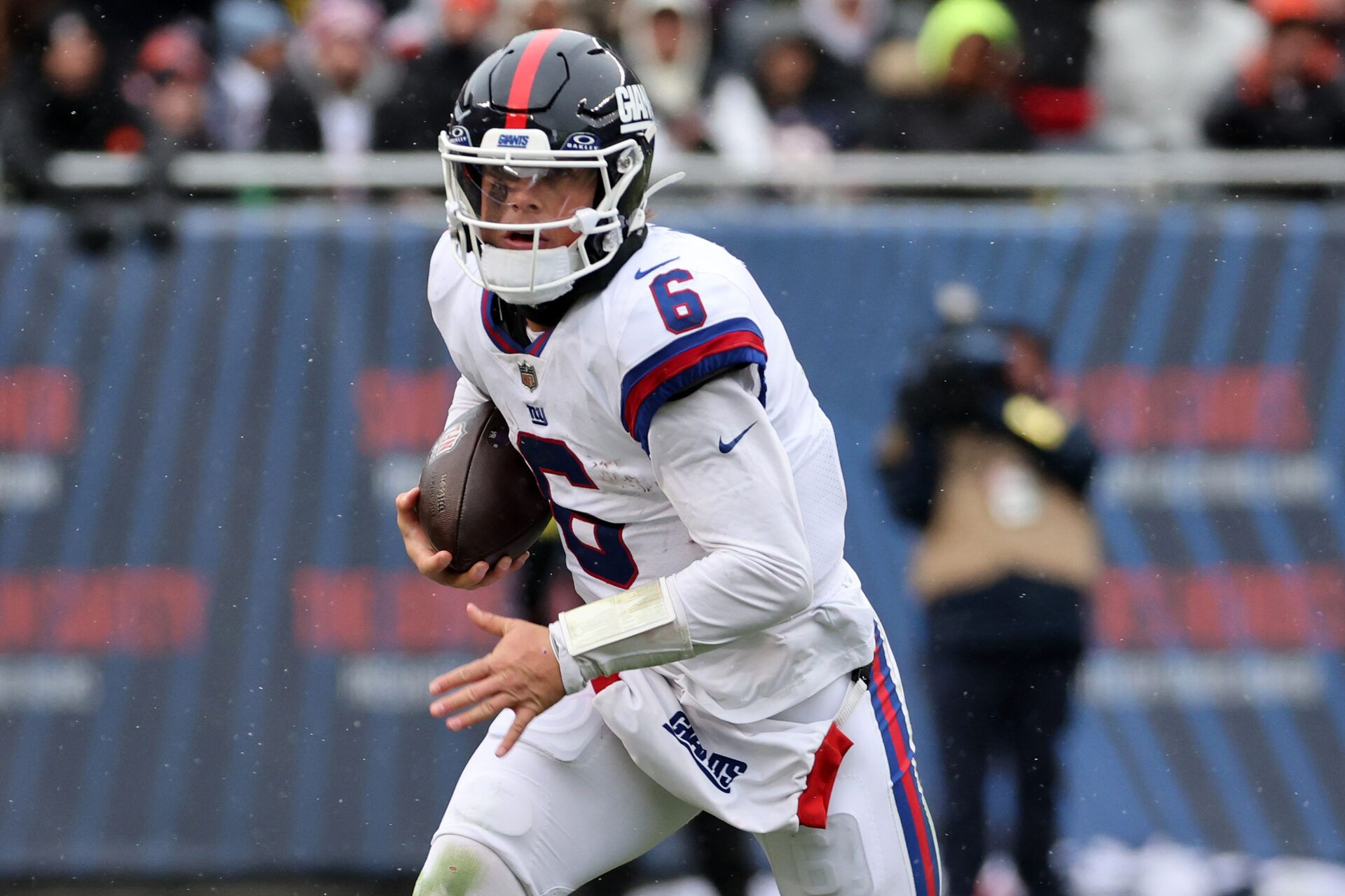 New York Giants quarterback Jaxson Dart (6) rushes the ball against the Chicago Bears during the second half at Soldier Field.