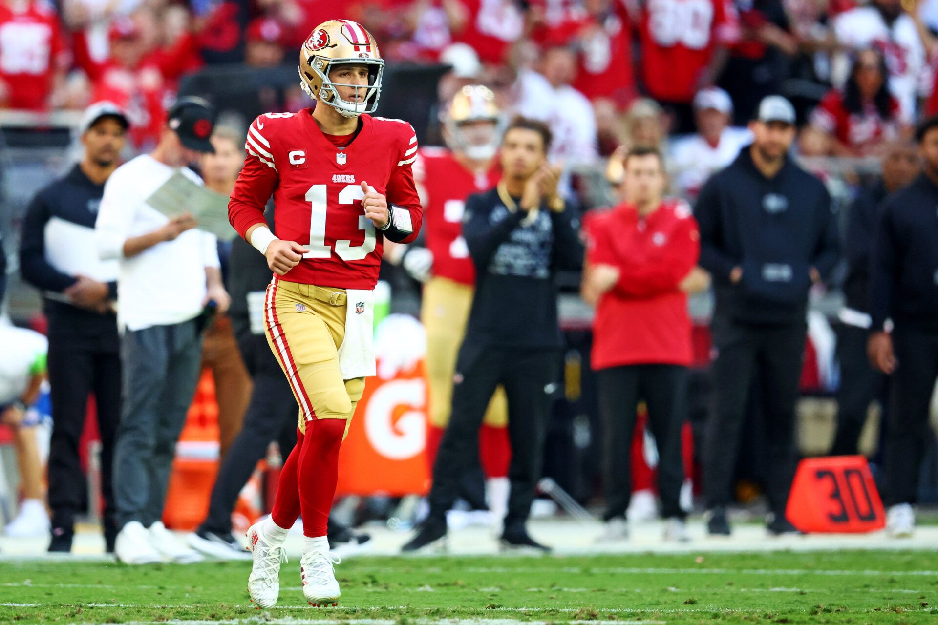 San Francisco 49ers quarterback Brock Purdy (13) comes back into the game after an injury during the first half against the Arizona Cardinals at State Farm Stadium.