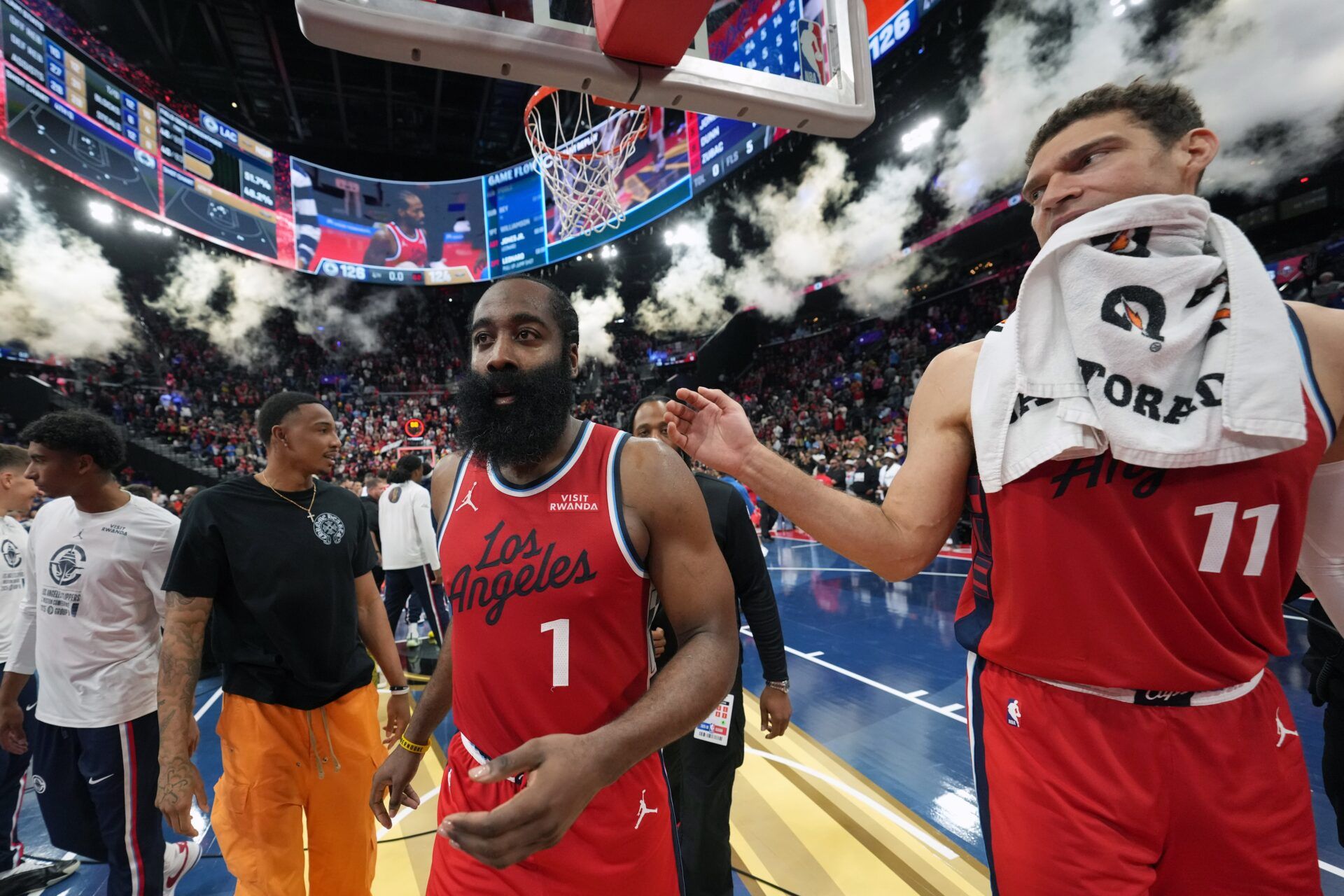 LA Clippers guard James Harden (1) and center Brook Lopez (11) leave the court after a 126-124 victory over the New Orleans Pelicans at Intuit Dome.