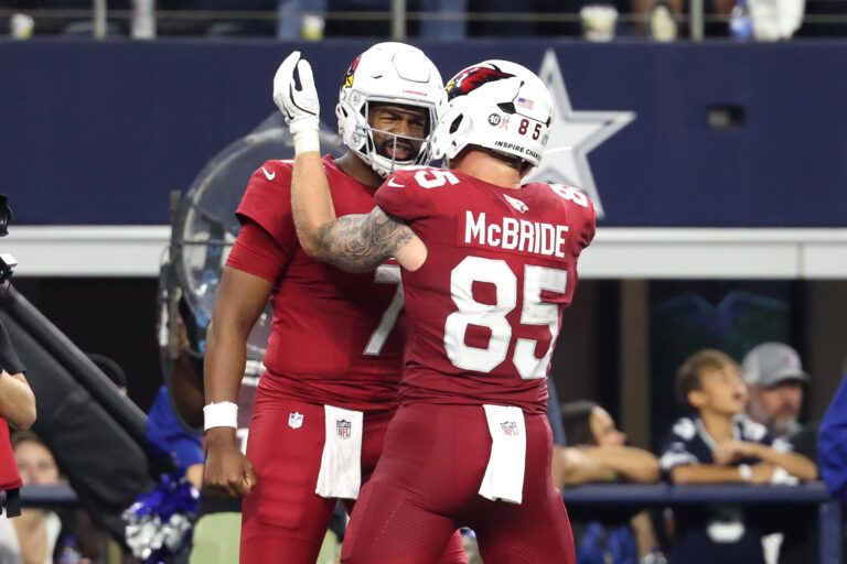Arizona Cardinals tight end Trey McBride (85) celebrates with quarterback Jacoby Brissett (7) after scoring a touchdown against the Dallas Cowboys in the second half at AT&T Stadium.