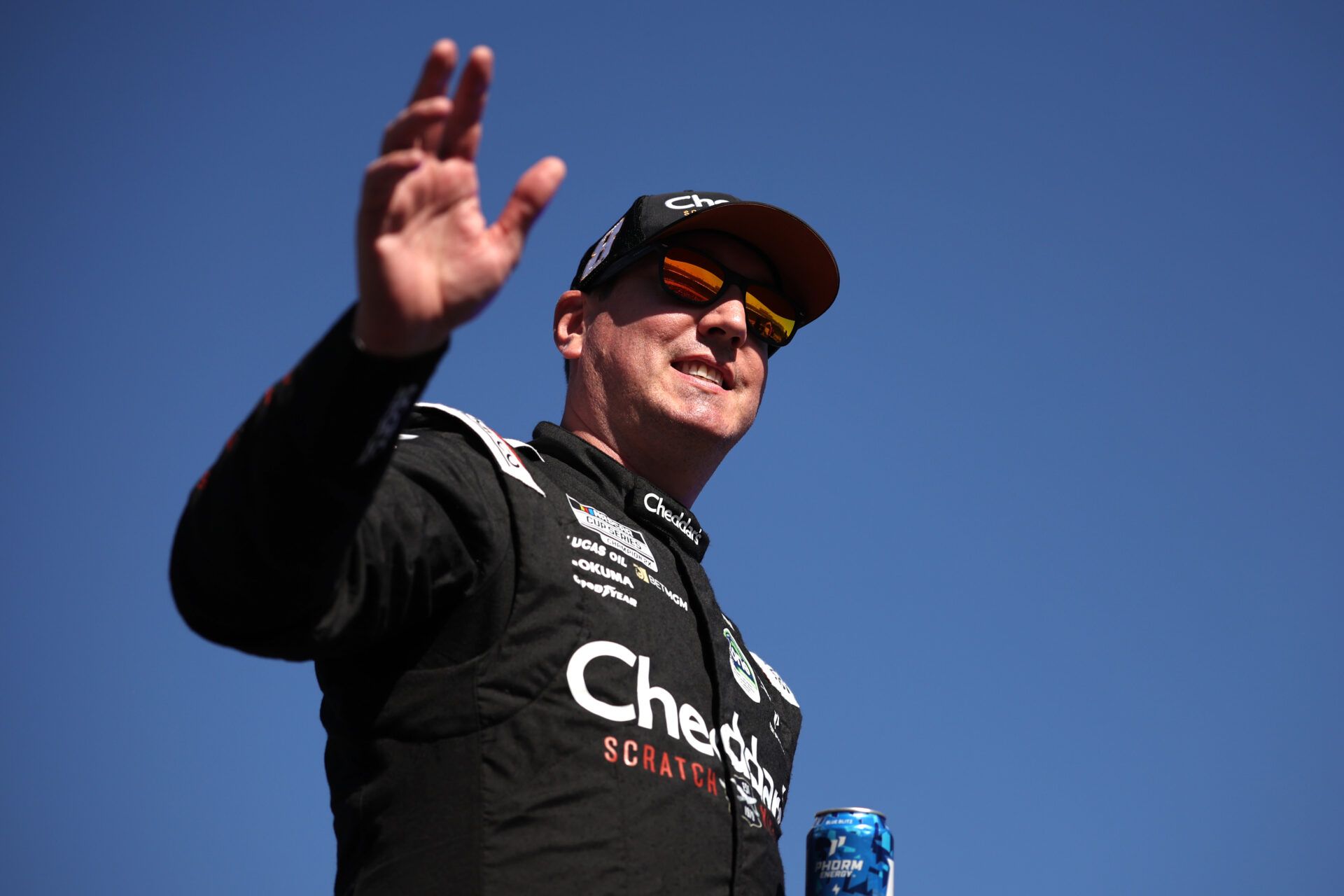 AVONDALE, ARIZONA - NOVEMBER 02: Kyle Busch, driver of the #8 Cheddar's Scratch Kitchen Chevrolet, waves to fans as he walks onstage during driver intros prior to the NASCAR Cup Series Championship at Phoenix Raceway on November 02, 2025 in Avondale, Arizona. (Photo by James Gilbert/Getty Images)
