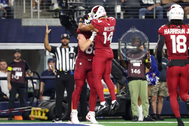 Arizona Cardinals tight end Trey McBride (85) celebrates with wide receiver Michael Wilson (14) after scoring a touchdown against the Dallas Cowboys in the second half at AT&T Stadium.