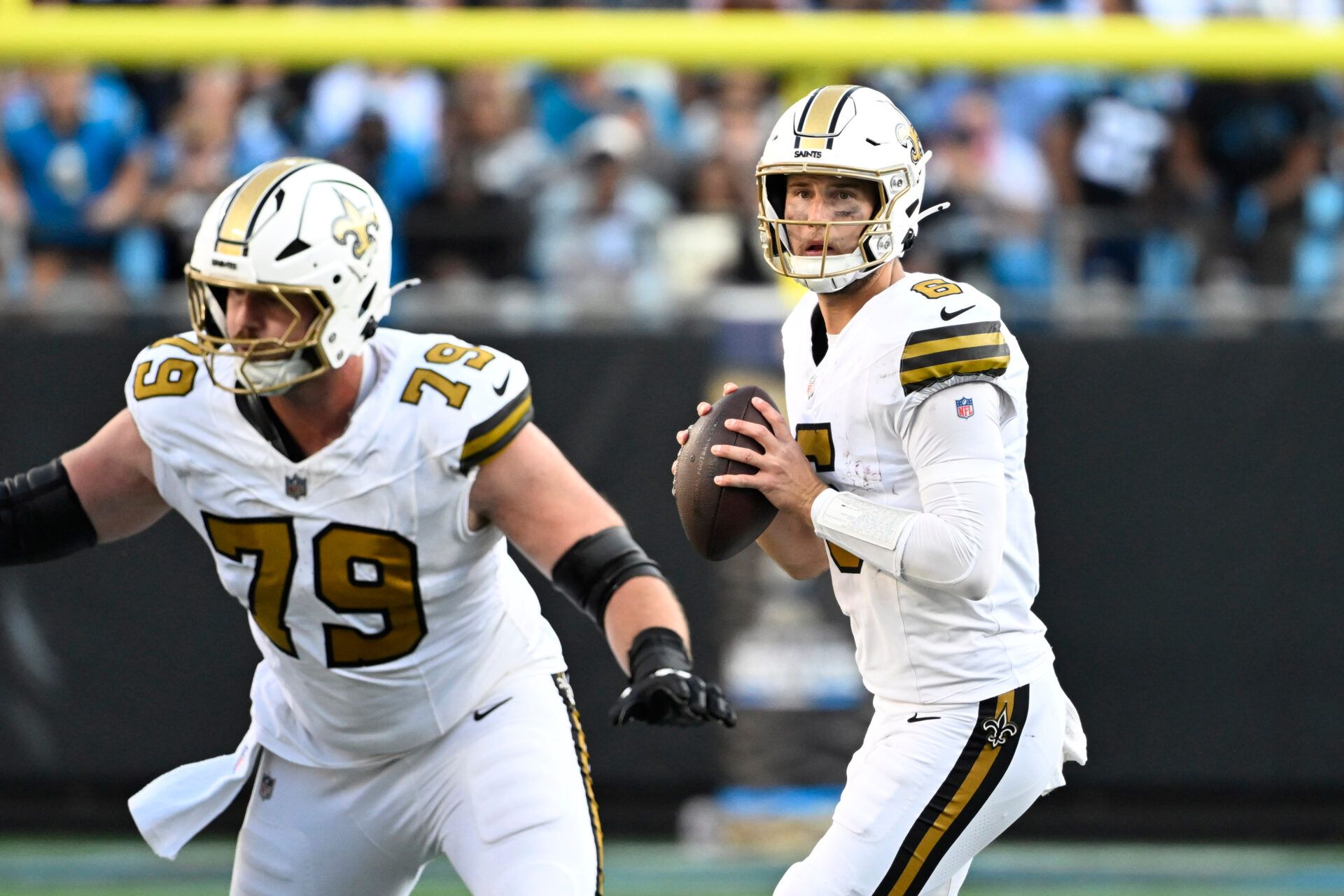 New Orleans Saints quarterback Tyler Shough (6) looks to pass as center Luke Fortner (79) blocks in the fourth quarter at Bank of America Stadium.