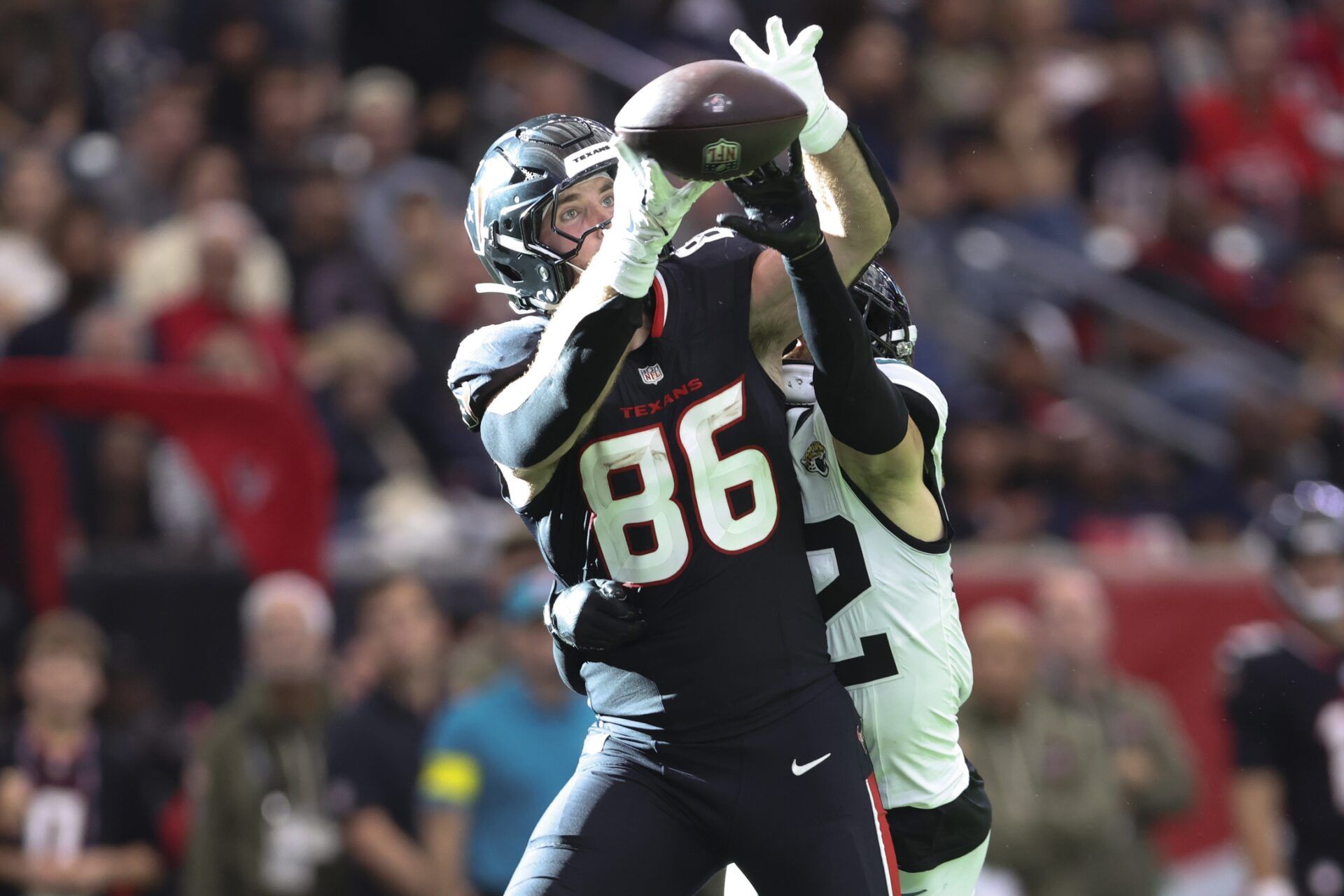 Houston Texans tight end Dalton Schultz (86) attempts to make a recption as Jacksonville Jaguars safety Andrew Wingard (42) defends during the fourth quarter at NRG Stadium.